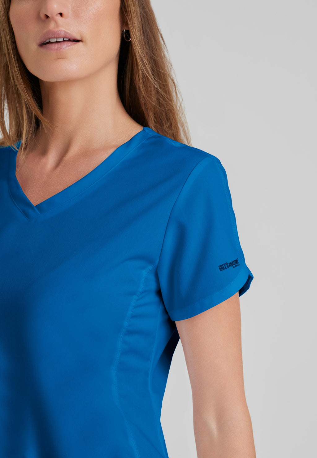 Detail Shot of the Cora 4-Pocket Scrub Top in New Royal from Grey's Anatomy™ by Barco Classic