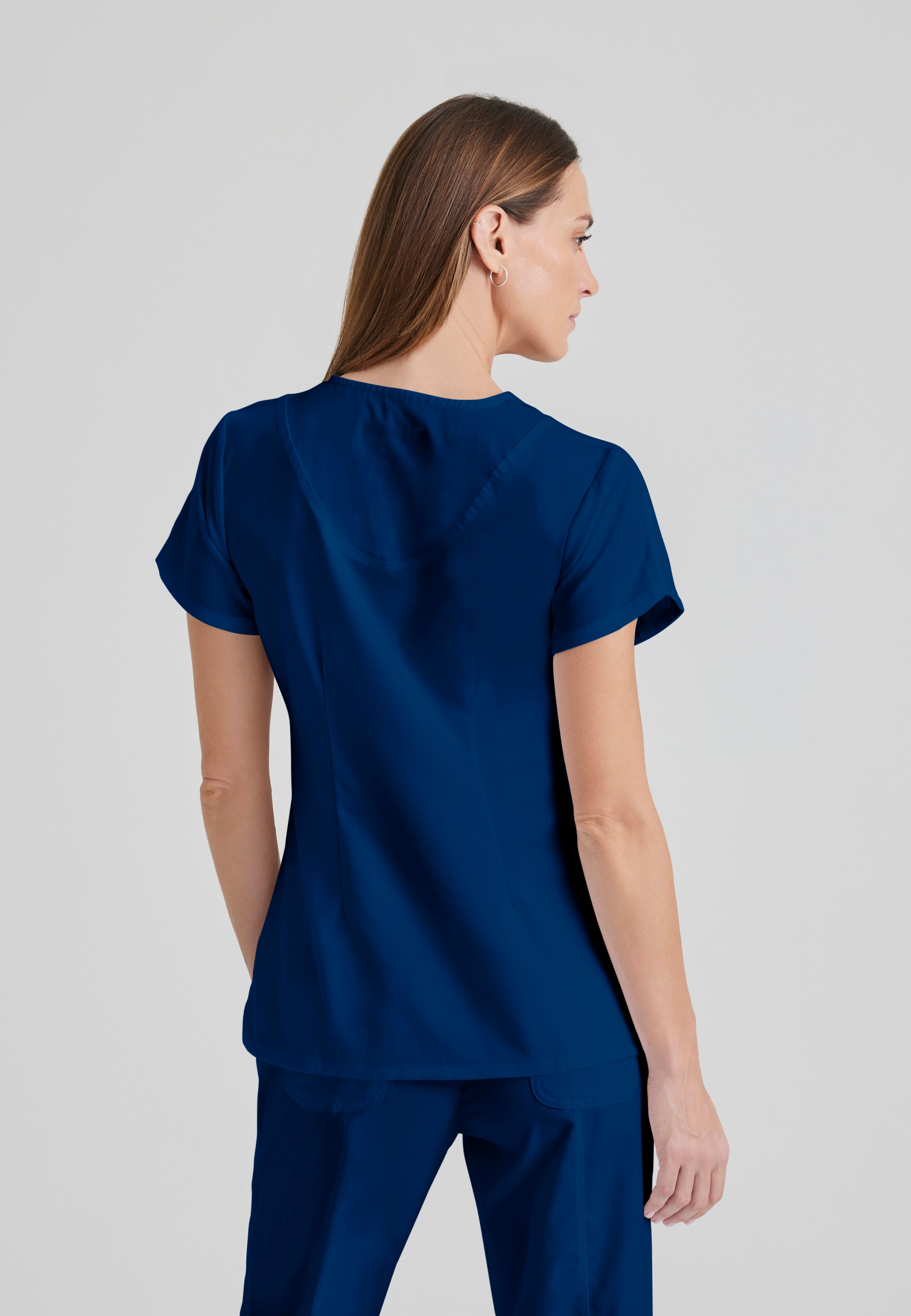 Back View of the Cora 4-Pocket Scrub Top in Indigo from Grey's Anatomy™ by Barco Classic