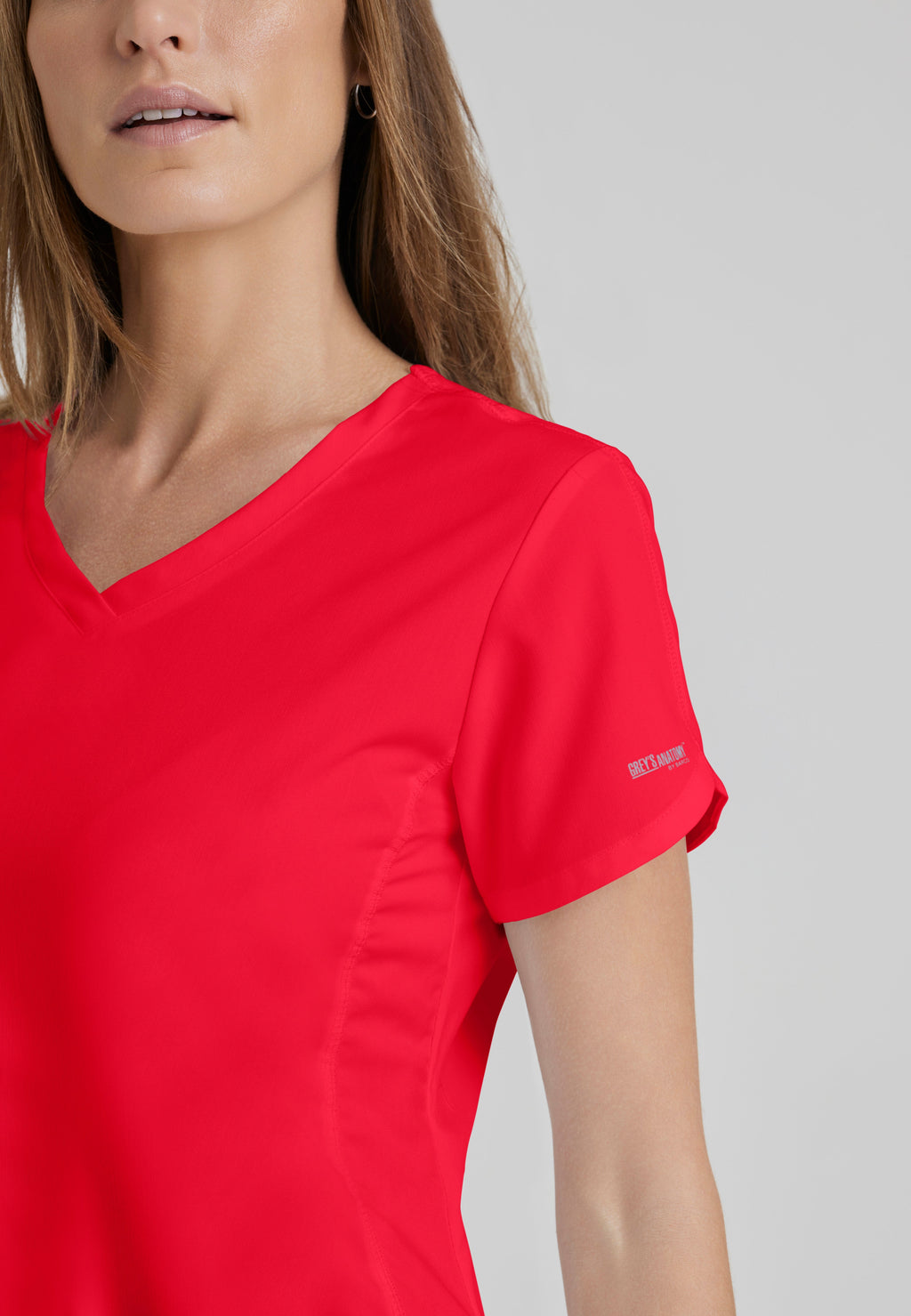 Detail Shot of the Cora 4-Pocket Scrub Top in Scarlet Red from Grey's Anatomy™ by Barco Classic