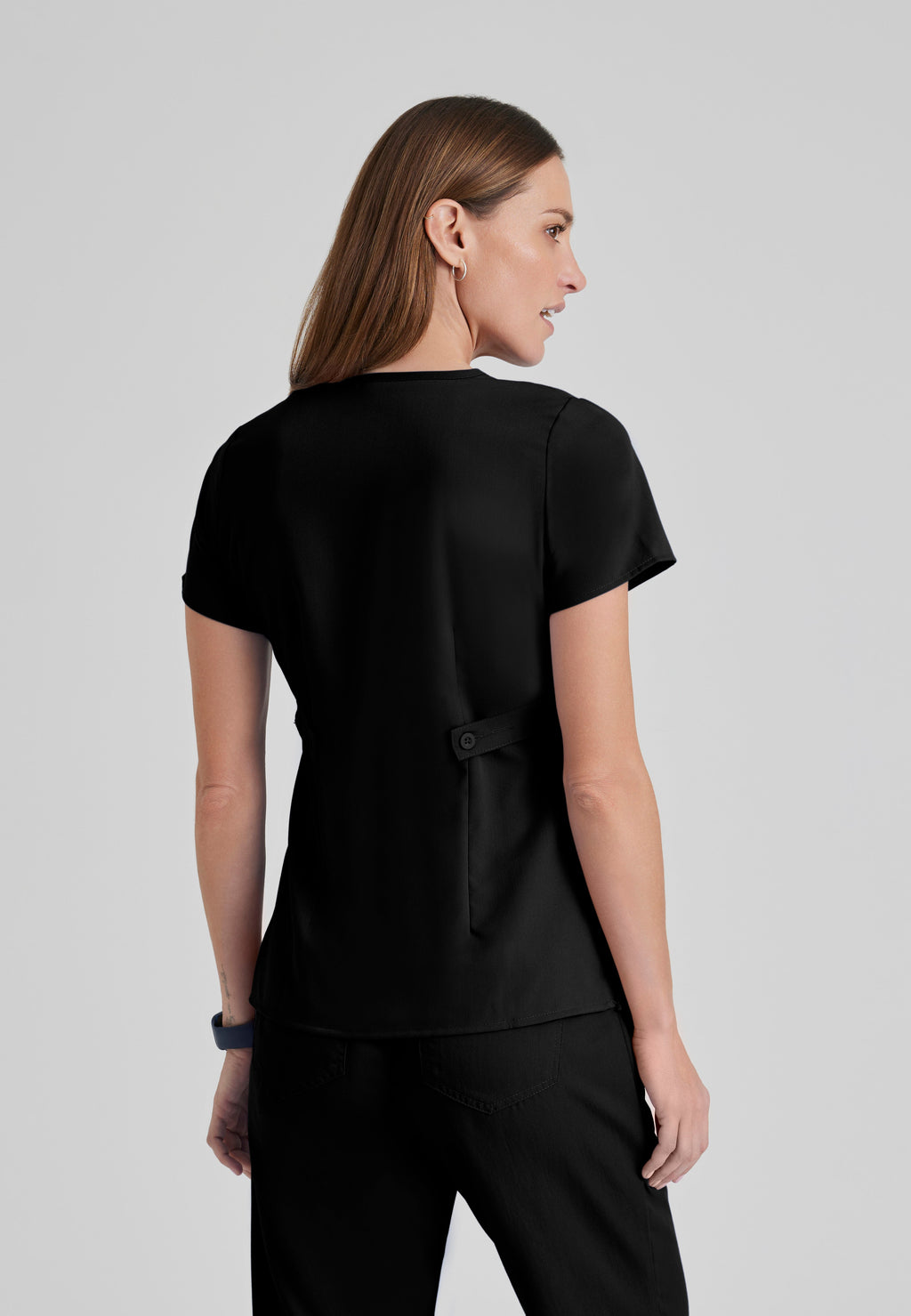 Back View of the Riley 3-Pocket Mock Wrap V-Neck Scrub Top in Black from Grey's Anatomy™ by Barco Classic