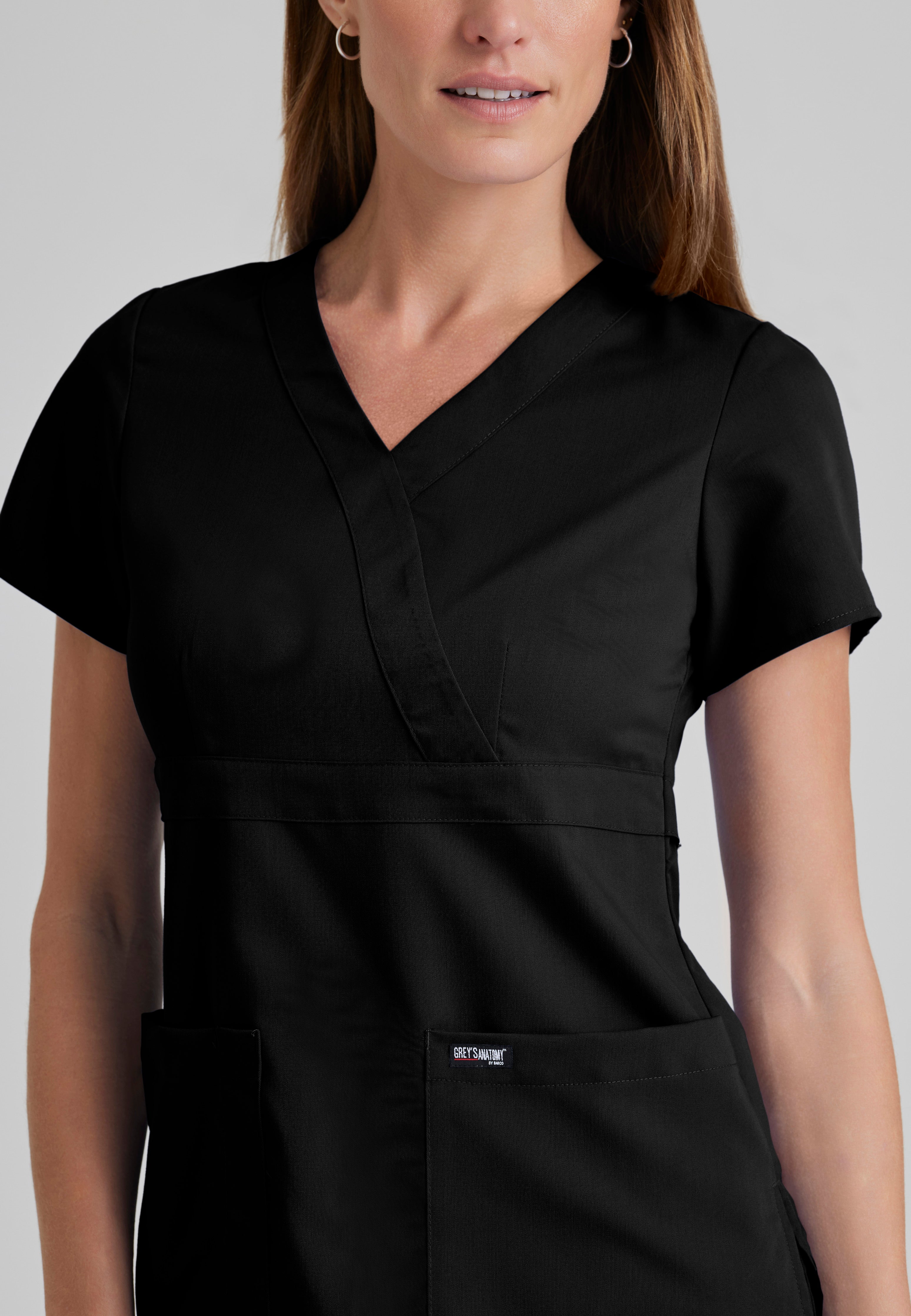 Detail Shot of the Riley 3-Pocket Mock Wrap V-Neck Scrub Top in Black from Grey's Anatomy™ by Barco Classic