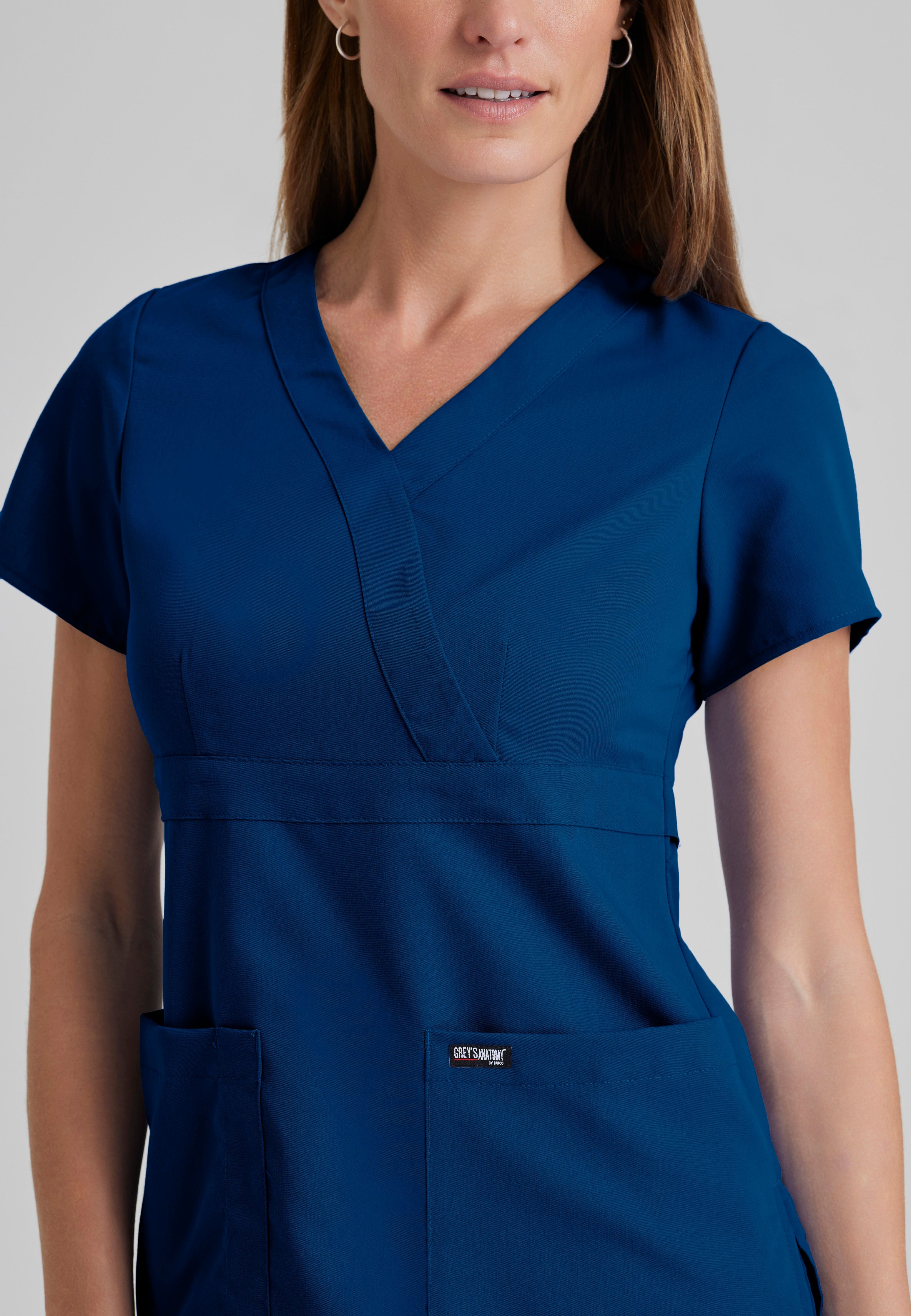 Detail Shot of the Riley 3-Pocket Mock Wrap V-Neck Scrub Top in Indigo from Grey's Anatomy™ by Barco Classic