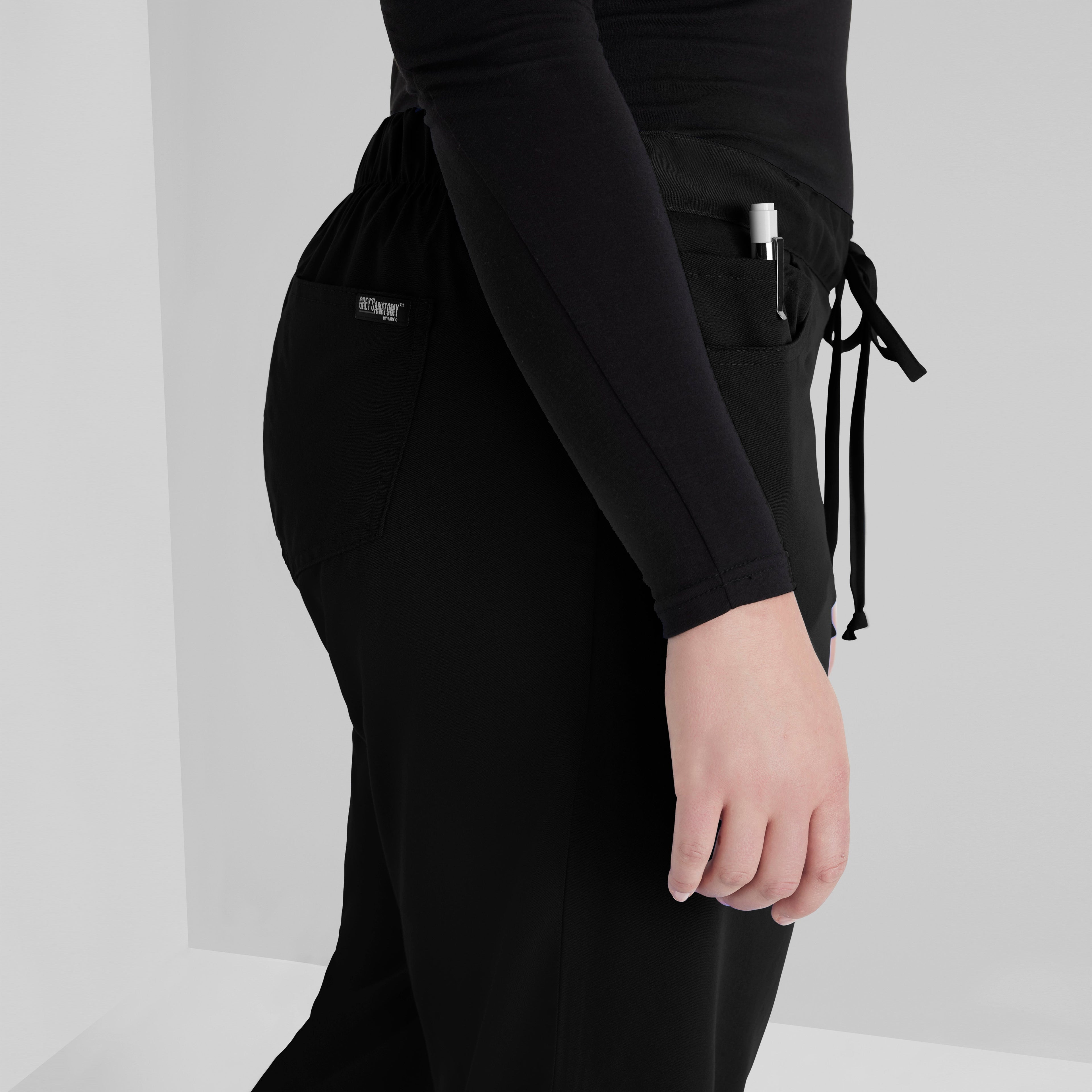 Grey's Anatomy Black Classic Riley Pant — 5 Pocket Scrub Pants. Flare leg. Mid rise. Drawcord waist with elastic back. 
