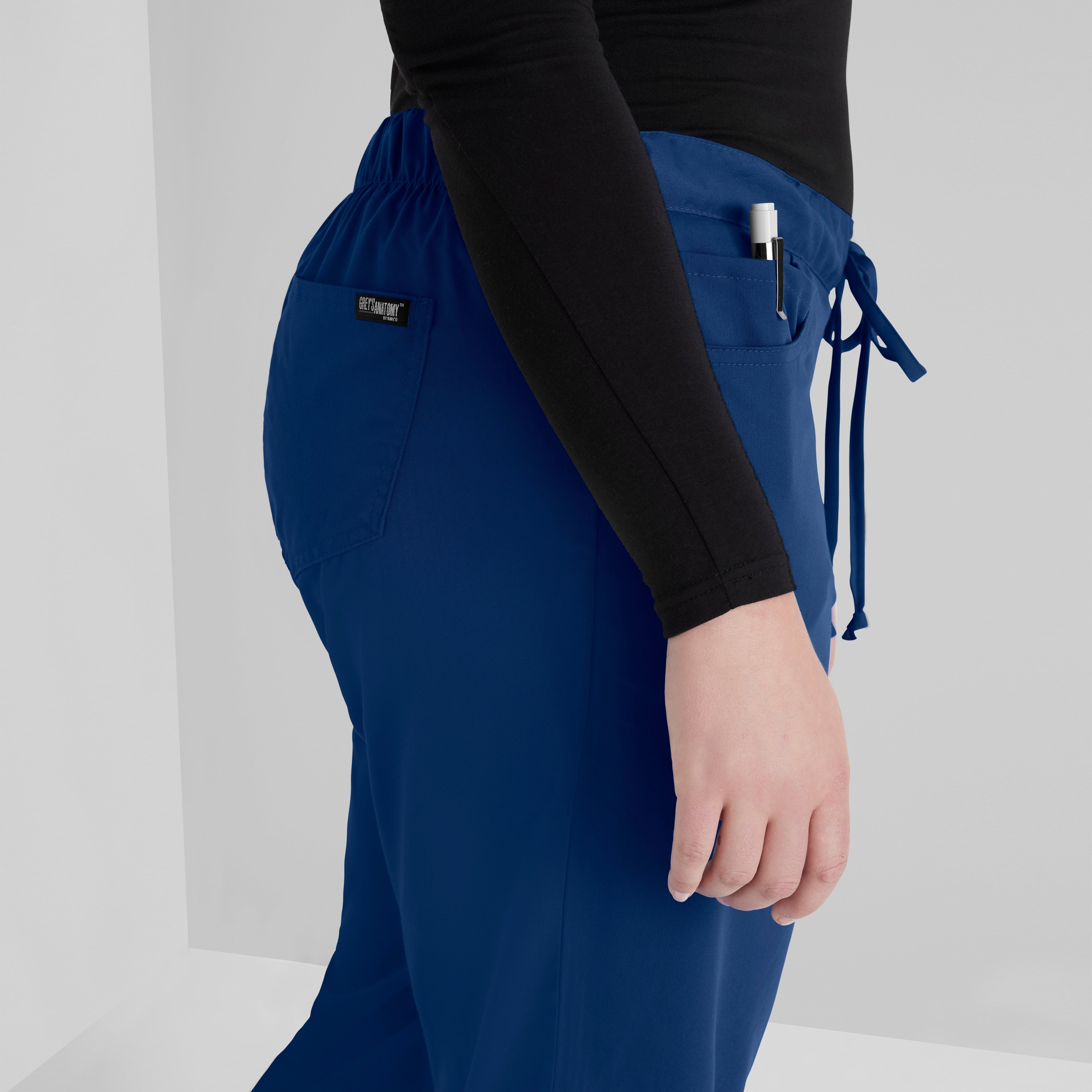 Grey's Anatomy Indigo Classic Riley Pant — 5 Pocket Scrub Pants. Flare leg. Mid rise. Drawcord waist with elastic back. 