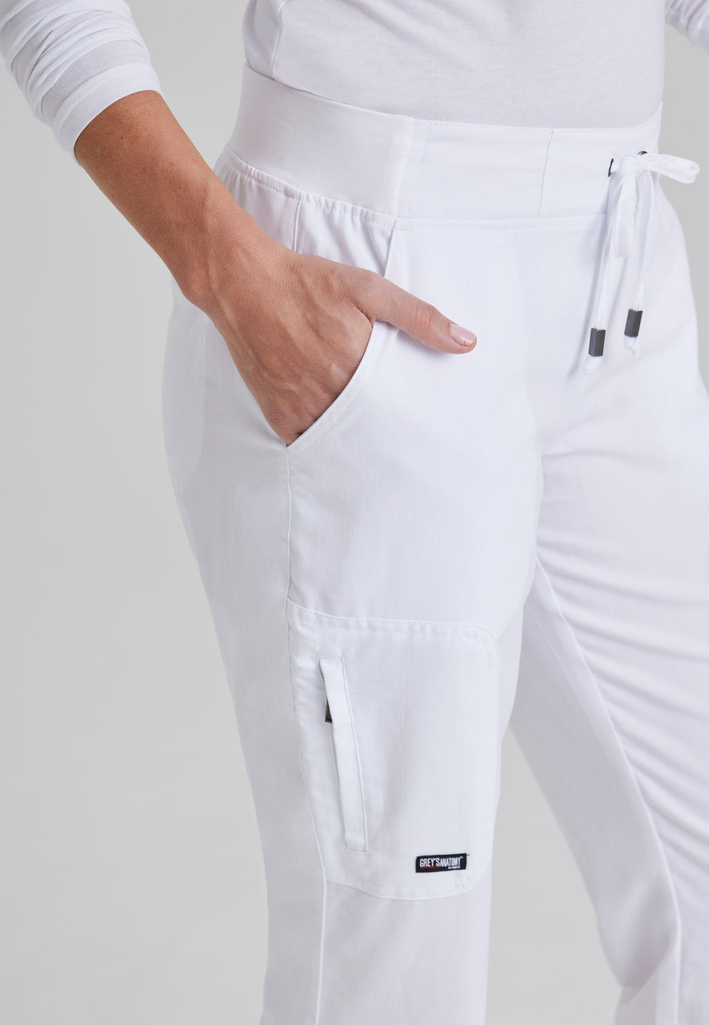 Detail Shot of the Mia 6-Pocket Mid-Rise Straight Leg Scrub Pant in White from Grey's Anatomy™ by Barco Classic