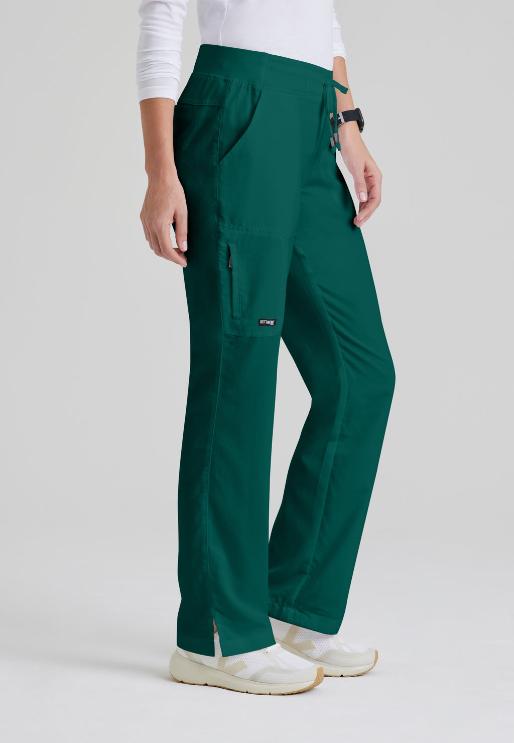 Side View of the Mia 6-Pocket Mid-Rise Straight Leg Scrub Pant in Hunter Green from Grey's Anatomy™ by Barco Classic