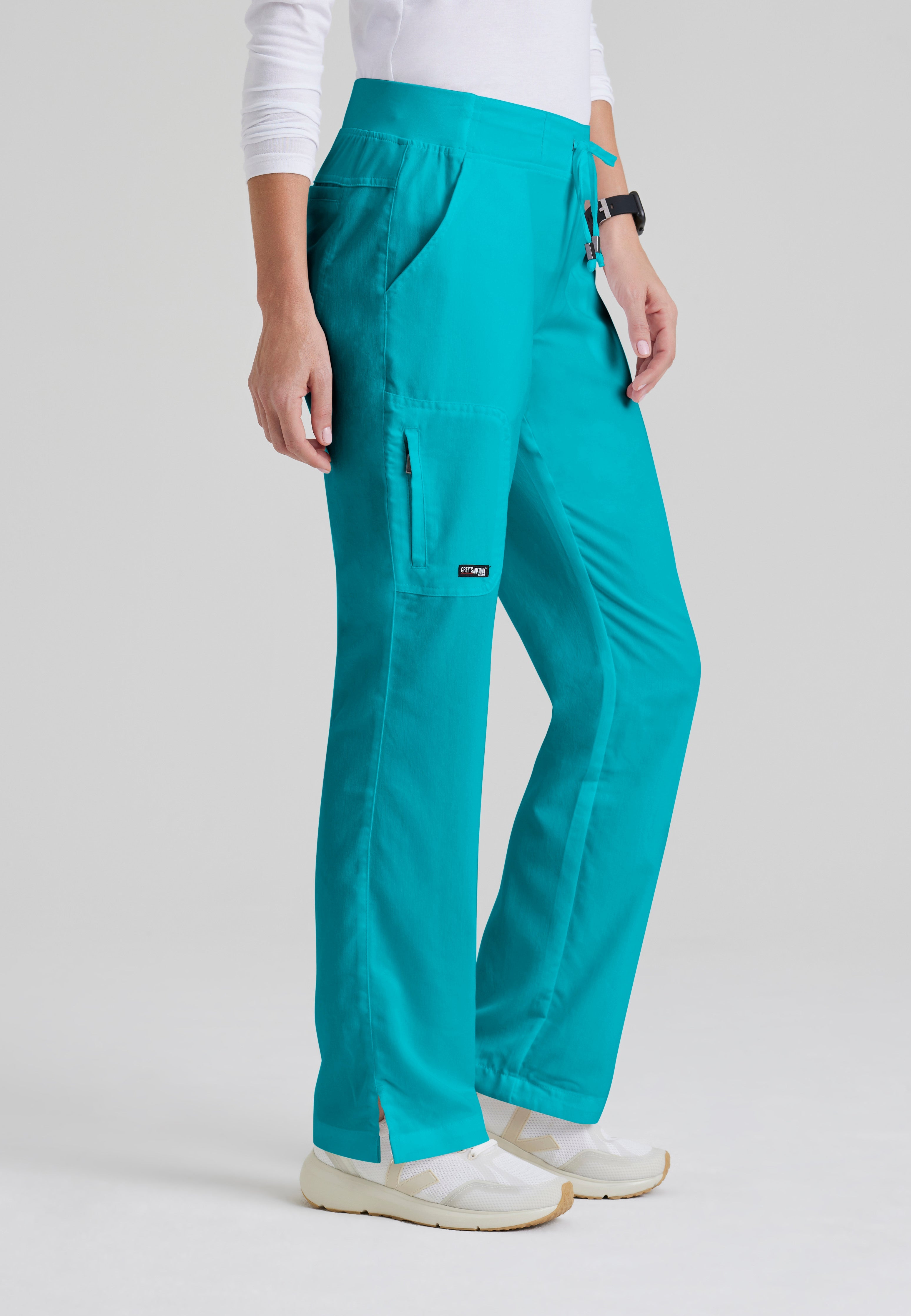 Side View of the Mia 6-Pocket Mid-Rise Straight Leg Scrub Pant in Teal from Grey's Anatomy™ by Barco Classic