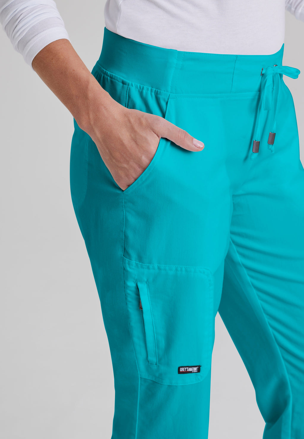 Detail Shot of the Mia 6-Pocket Mid-Rise Straight Leg Scrub Pant in Teal from Grey's Anatomy™ by Barco Classic