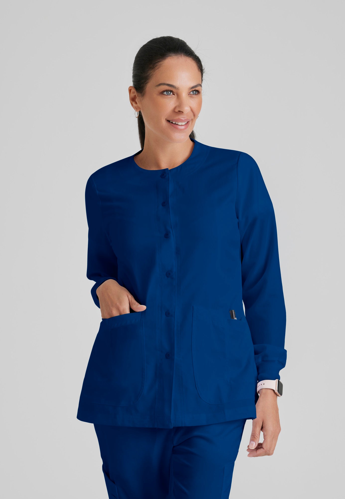 Front View of the Jamie 4-Pocket Crewneck Snap-Front Scrub Jacket in Indigo from Grey's Anatomy™ by Barco Classic