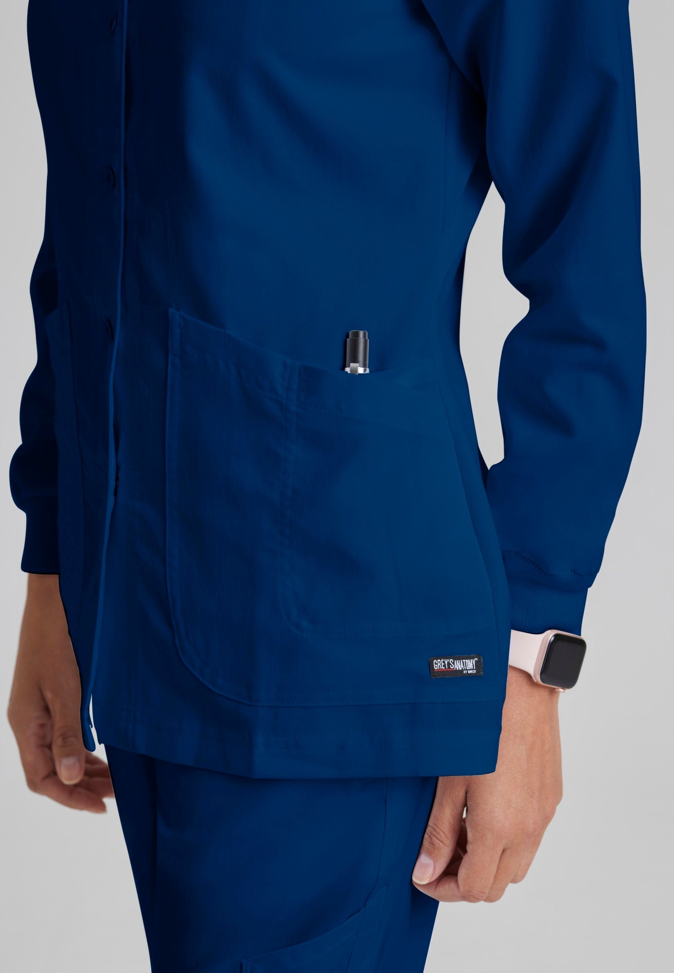 Detail Shot of the Jamie 4-Pocket Crewneck Snap-Front Scrub Jacket in Indigo from Grey's Anatomy™ by Barco Classic