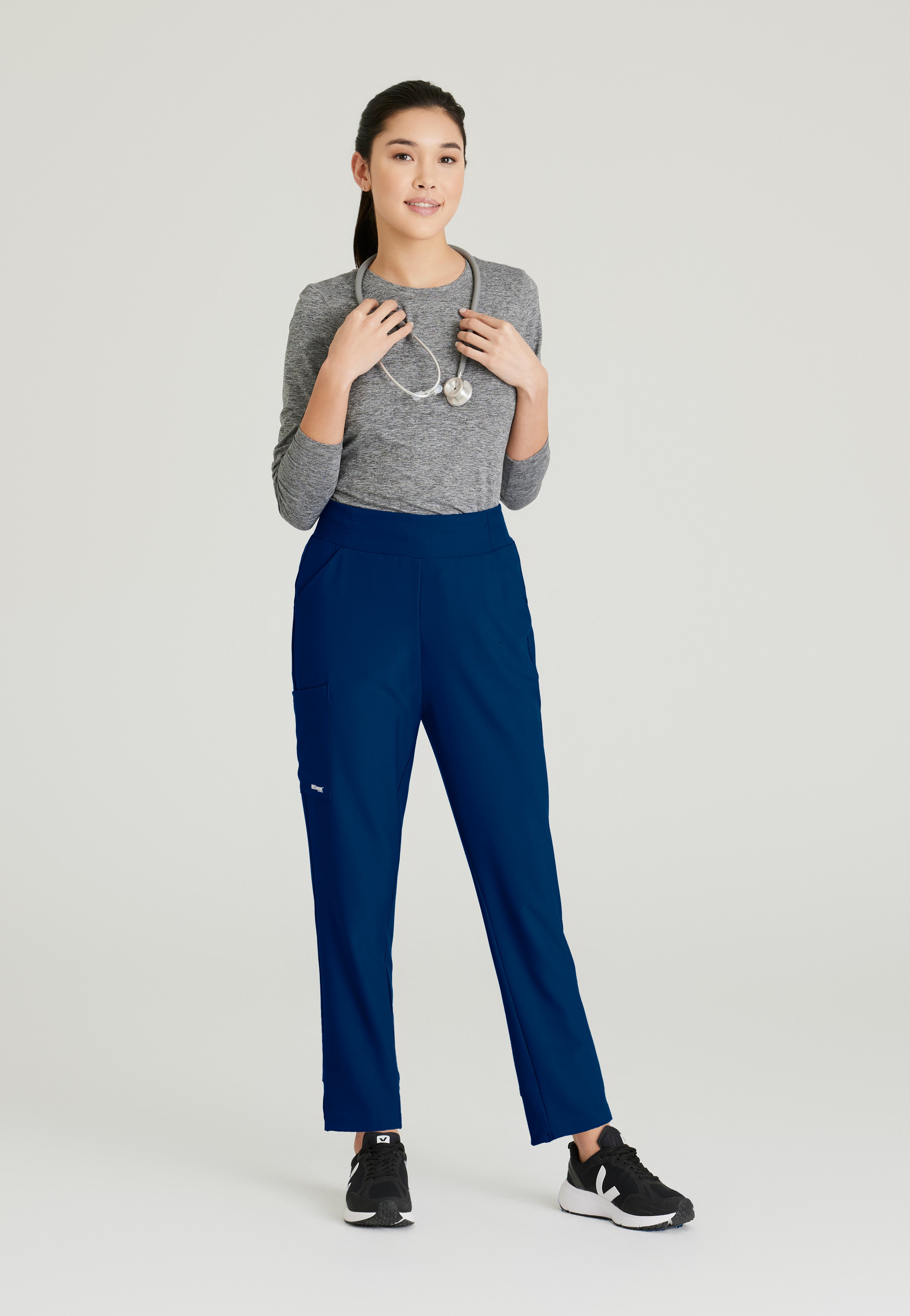 Full Body View of the Flight 5-Pocket High Rise Tapered Leg Pant in Indigo from Grey's Anatomy™ by Barco Evolve