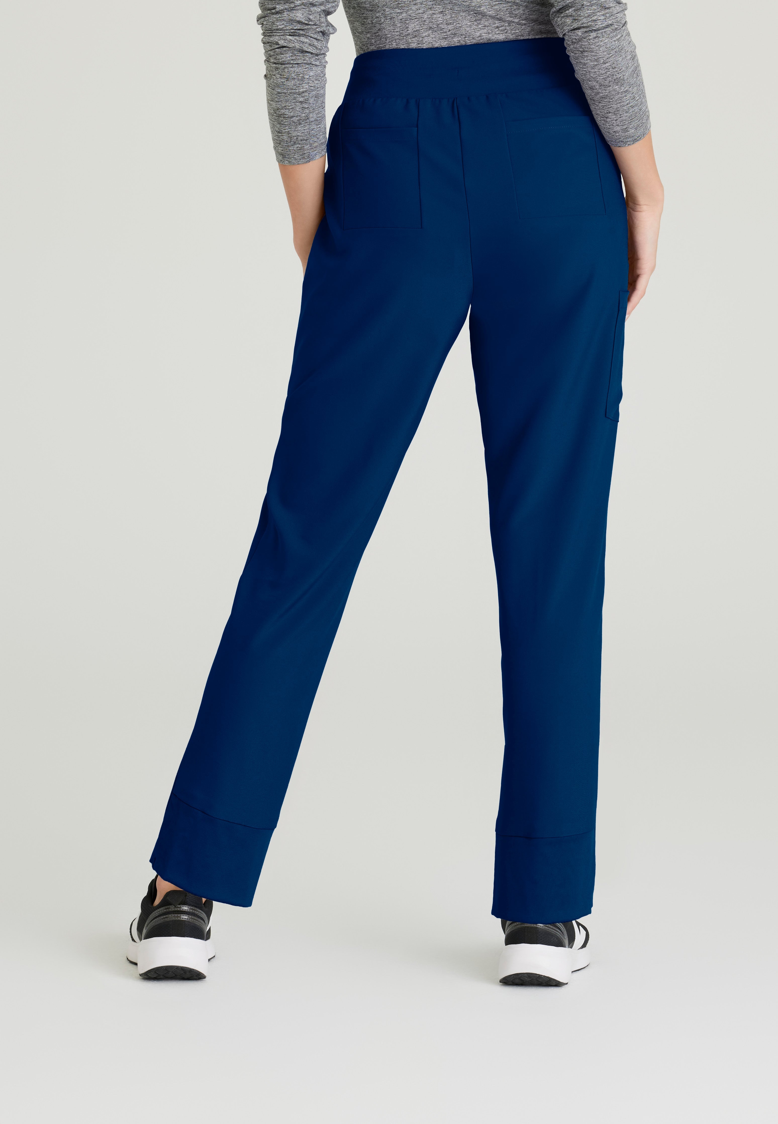 Back View of the Flight 5-Pocket High Rise Tapered Leg Pant in Indigo from Grey's Anatomy™ by Barco Evolve