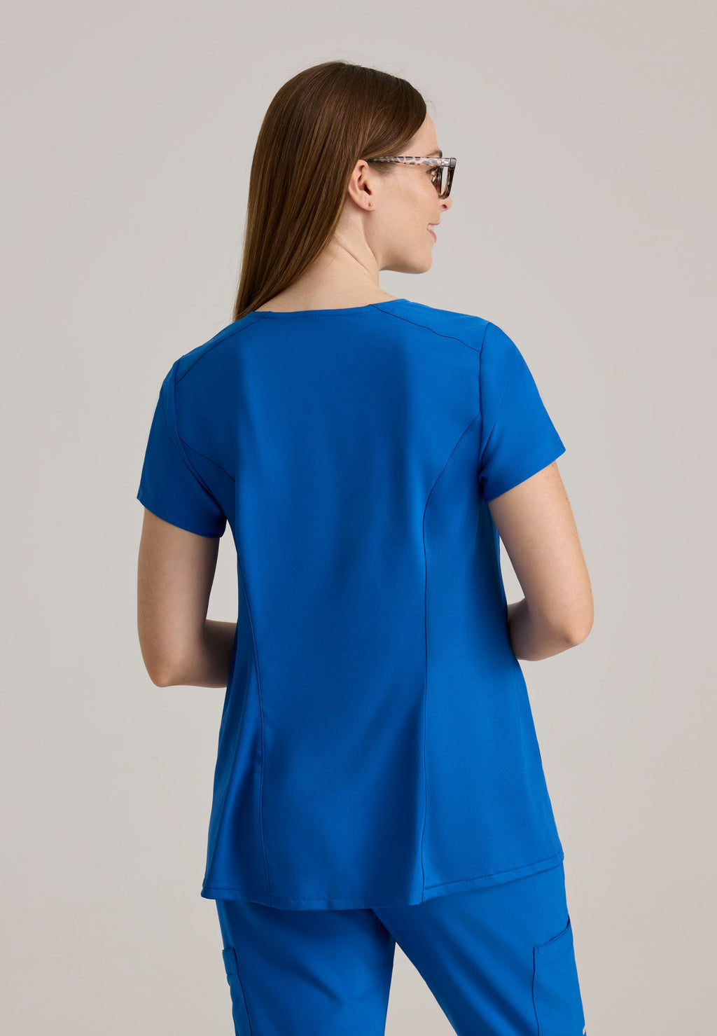 Back View of the Promise Maternity Top in New Royal from Grey's Anatomy™ by Barco Evolve