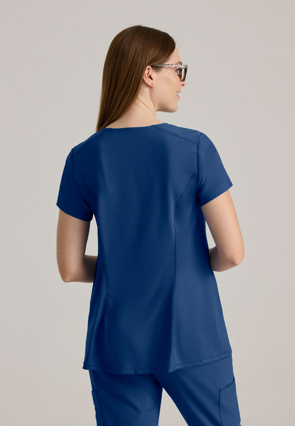 Back View of the Promise Maternity Top in Indigo from Grey's Anatomy™ by Barco Evolve