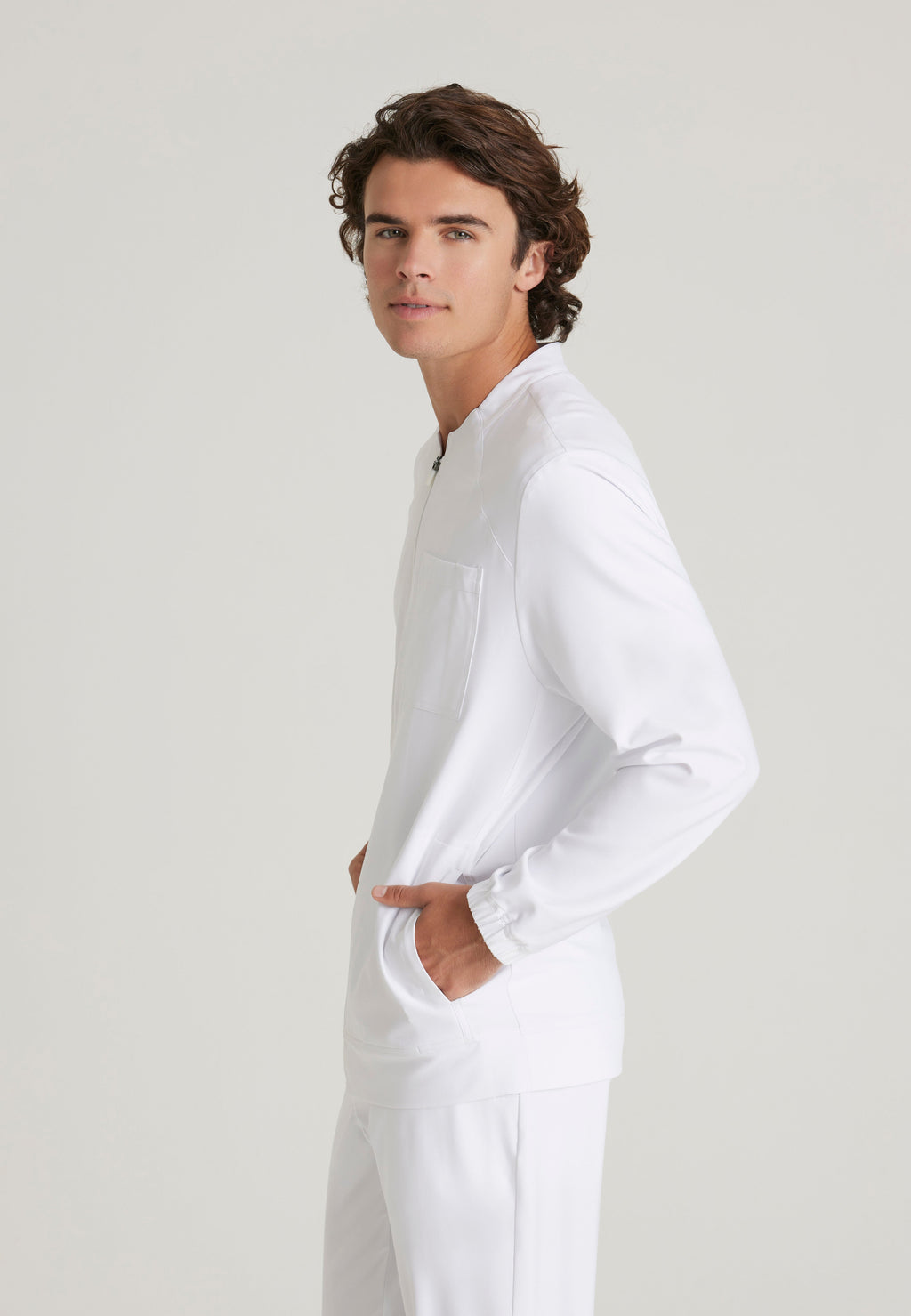 Side View of the Cycle 3-Pocket Crewneck Ciclo® Scrub Jacket in White from Grey's Anatomy™ by Barco Evolve