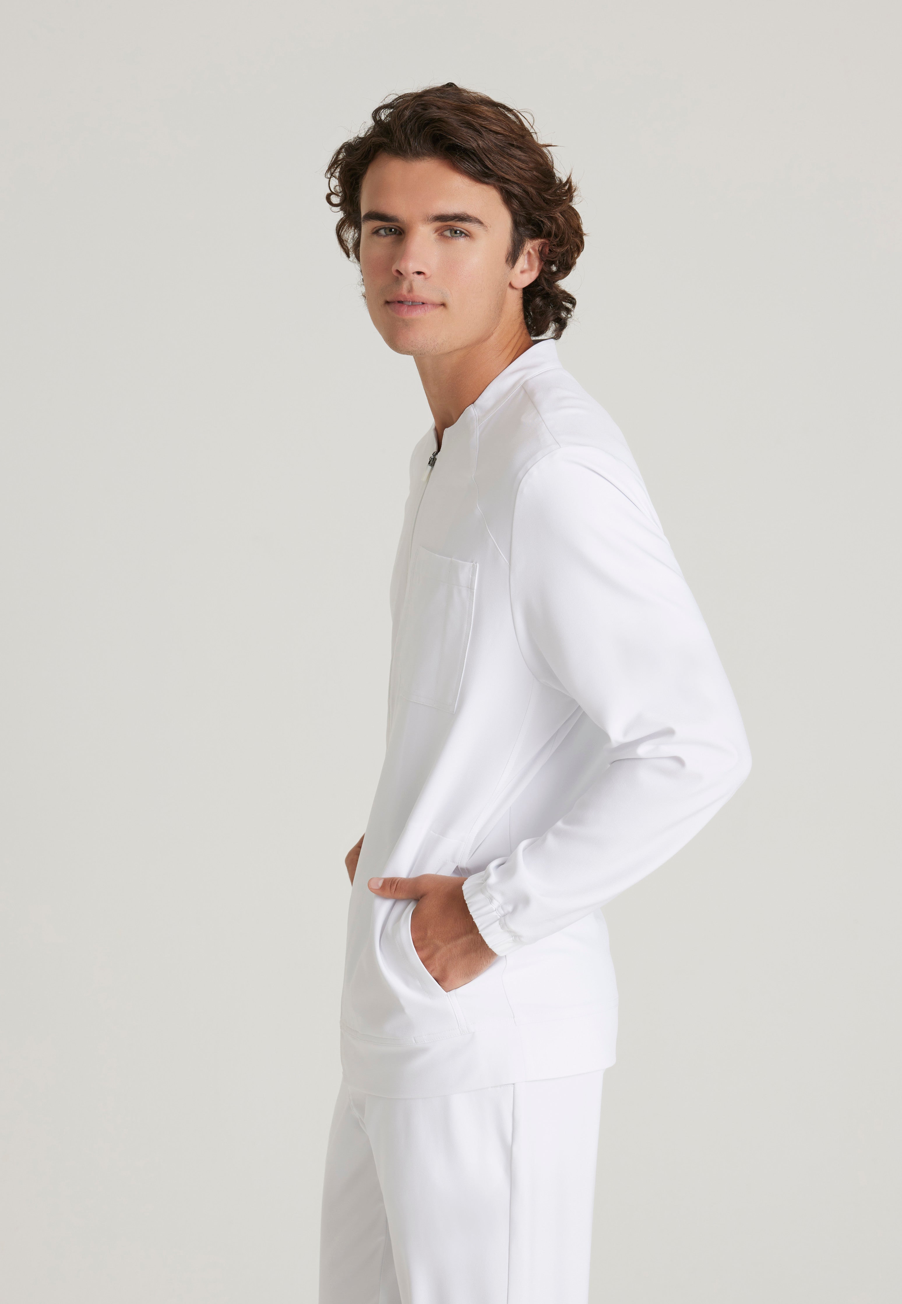 Side View of the Cycle 3-Pocket Crewneck Ciclo® Scrub Jacket in White from Grey's Anatomy™ by Barco Evolve