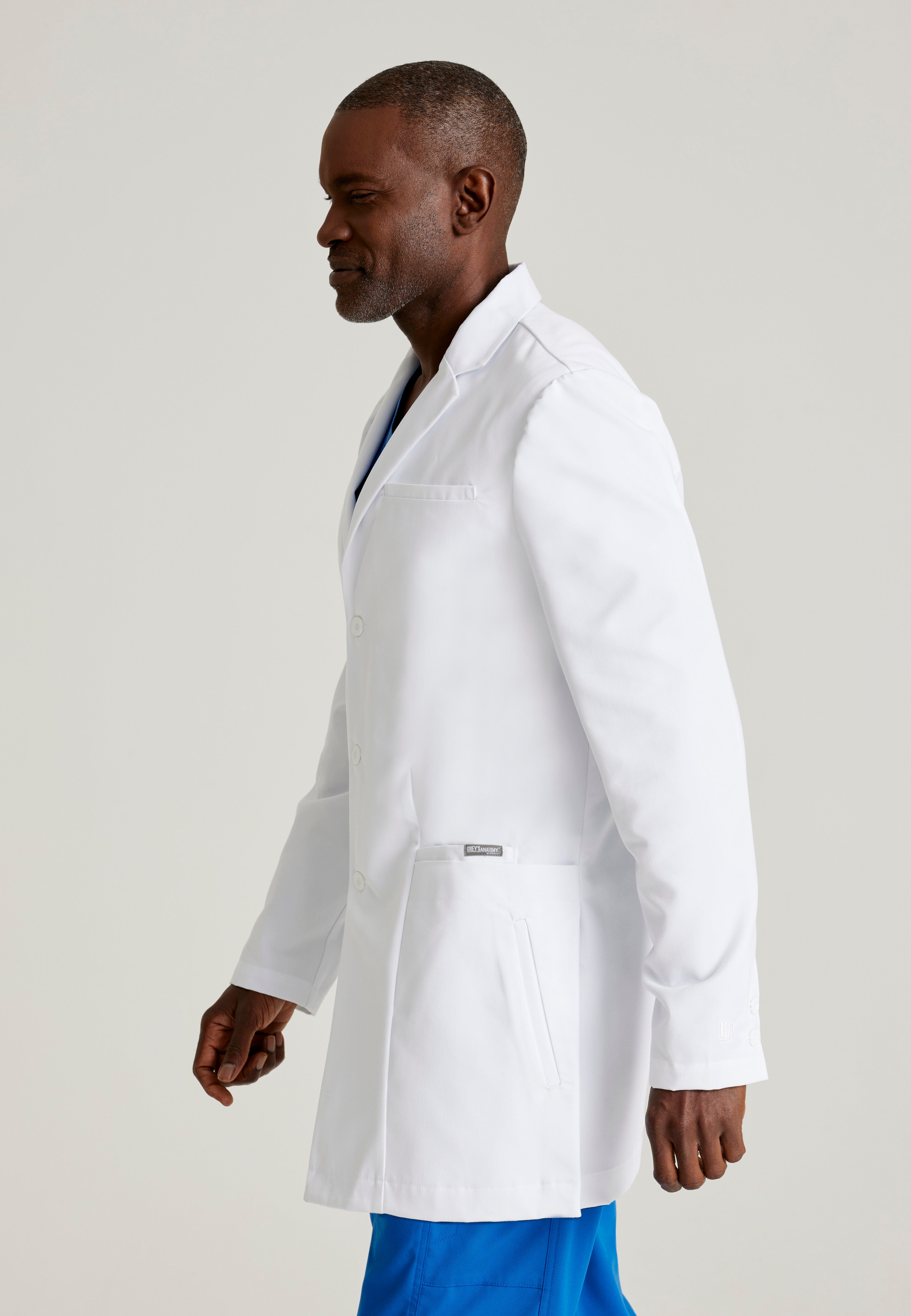 Side View of the Derek 6-Pocket 35" 3-Button Lab Coat in White from Grey's Anatomy™ by Barco Classic