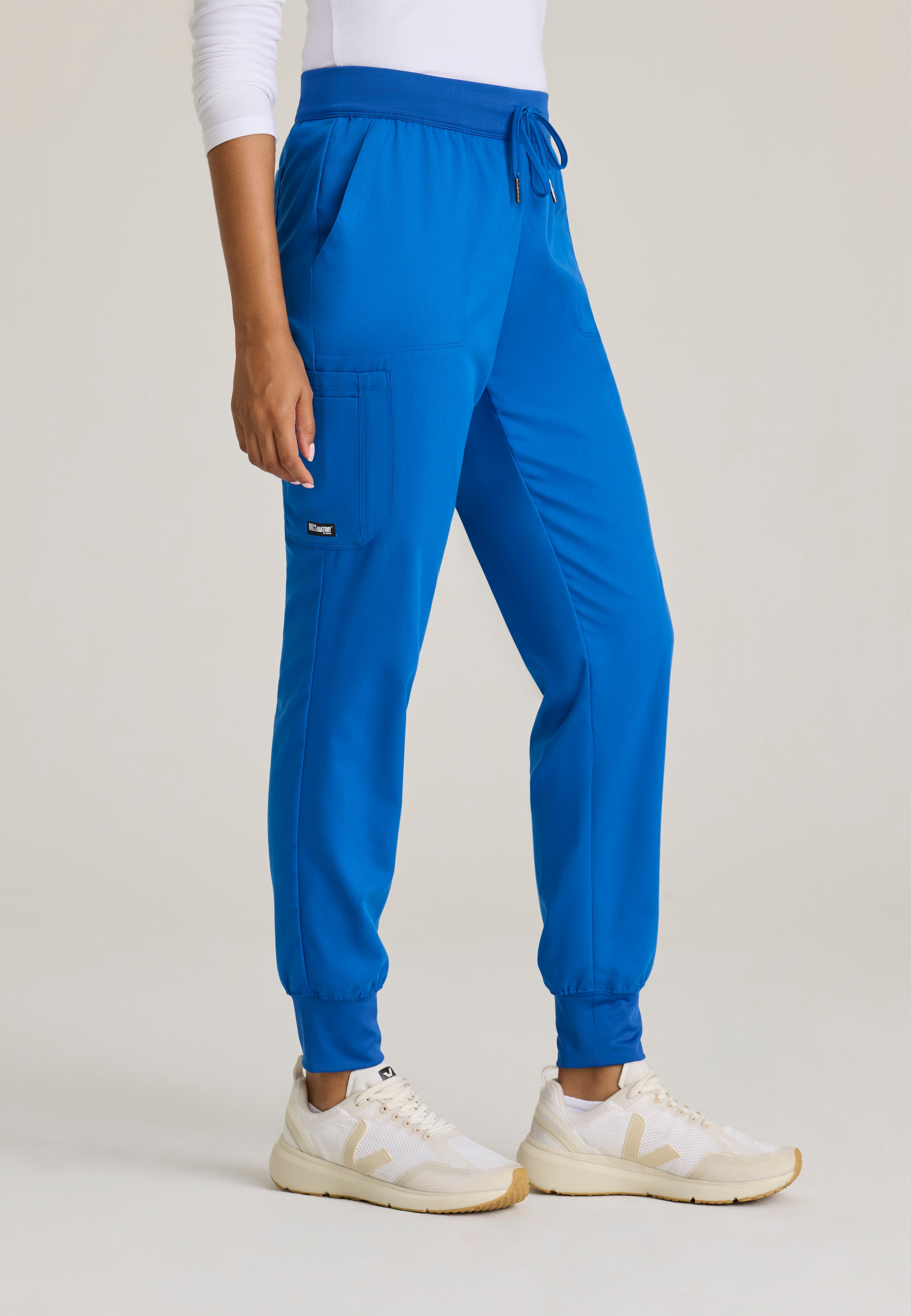 Side View of the Finley 6-Pocket Knit Waistband Jogger in New Royal from Grey's Anatomy™ by Barco Classic