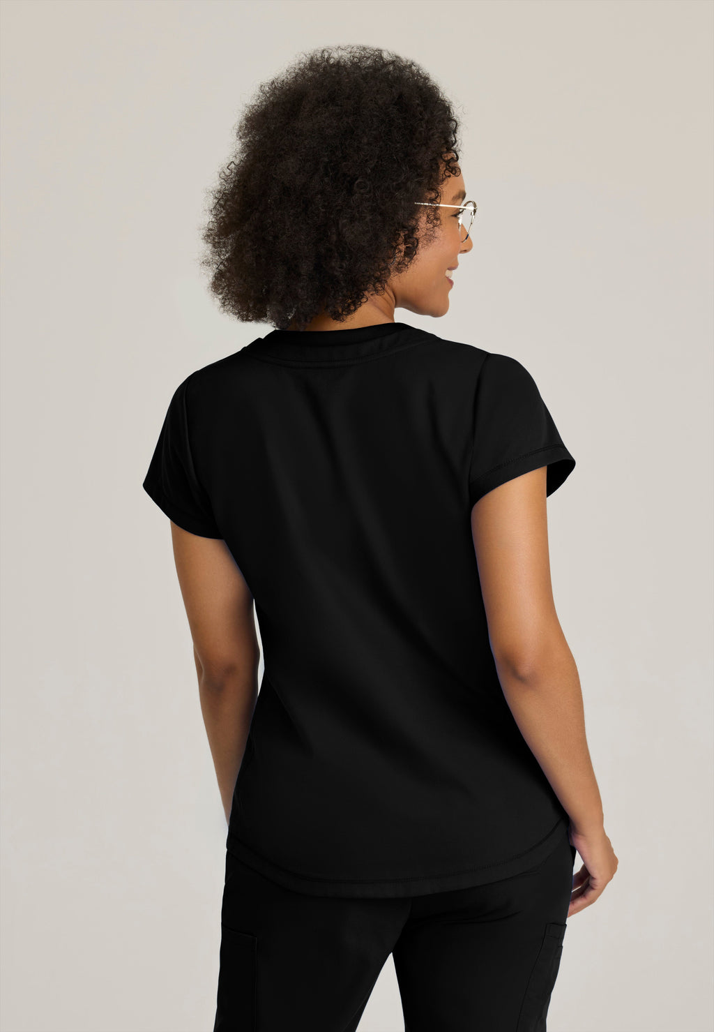 Back View of the Evelyn Pintuck Detail Scrub Top in Black from Grey's Anatomy™ by Barco Classic
