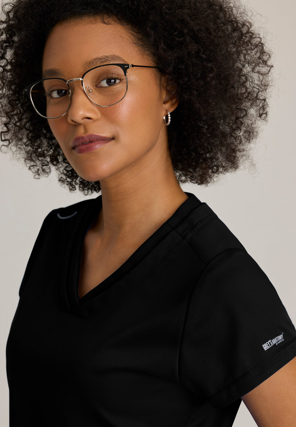 Detail Shot of the Evelyn Pintuck Detail Scrub Top in Black from Grey's Anatomy™ by Barco Classic