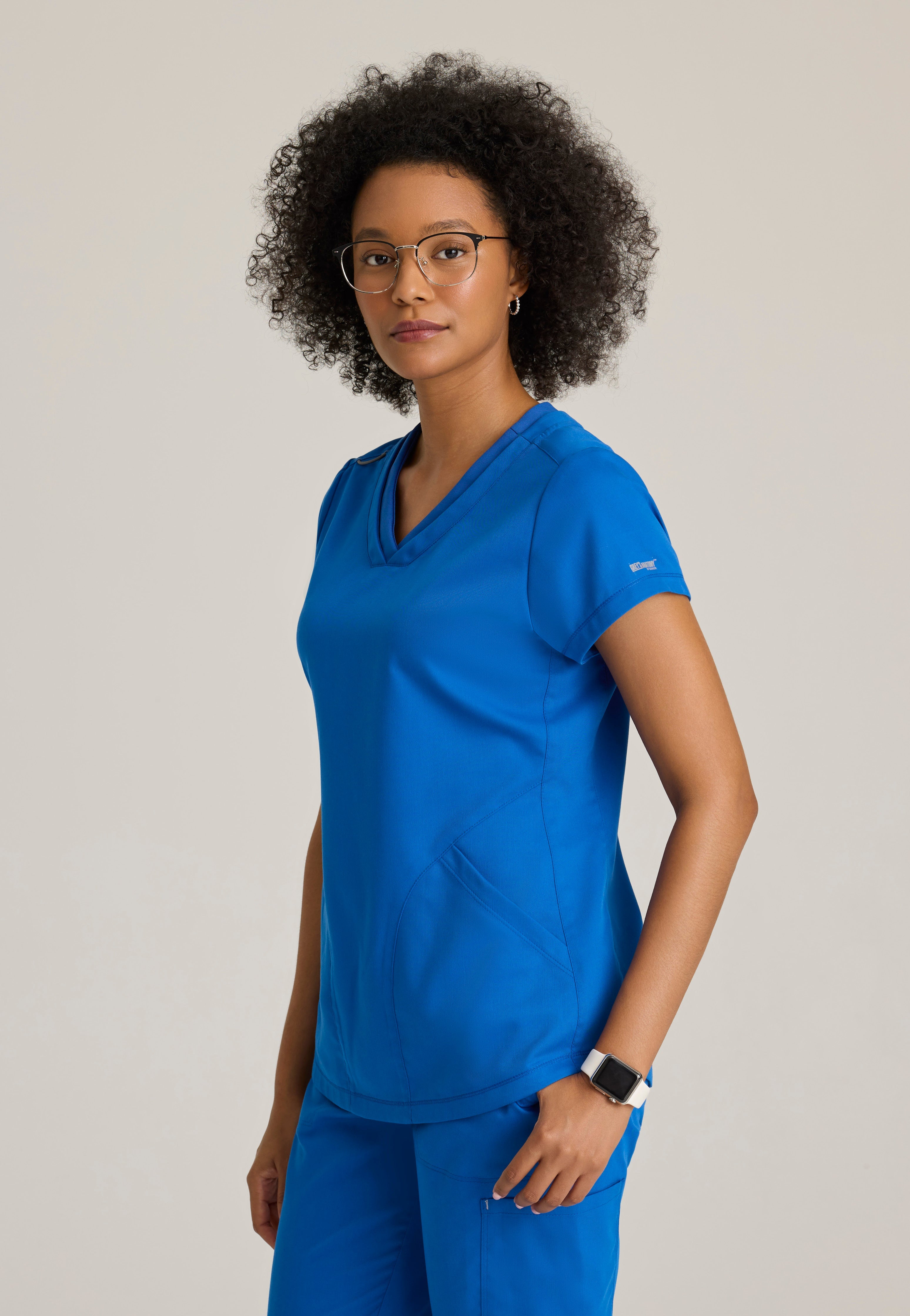 Side View of the Evelyn Pintuck Detail Scrub Top in New Royal from Grey's Anatomy™ by Barco Classic