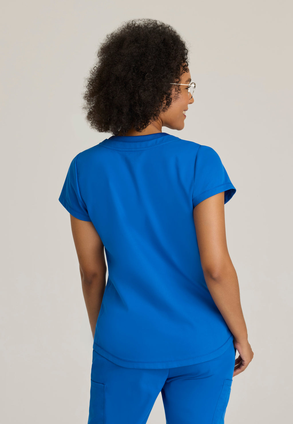 Back View of the Evelyn Pintuck Detail Scrub Top in New Royal from Grey's Anatomy™ by Barco Classic