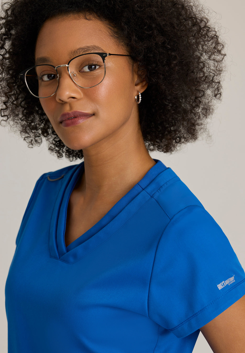 Detail Shot of the Evelyn Pintuck Detail Scrub Top in New Royal from Grey's Anatomy™ by Barco Classic