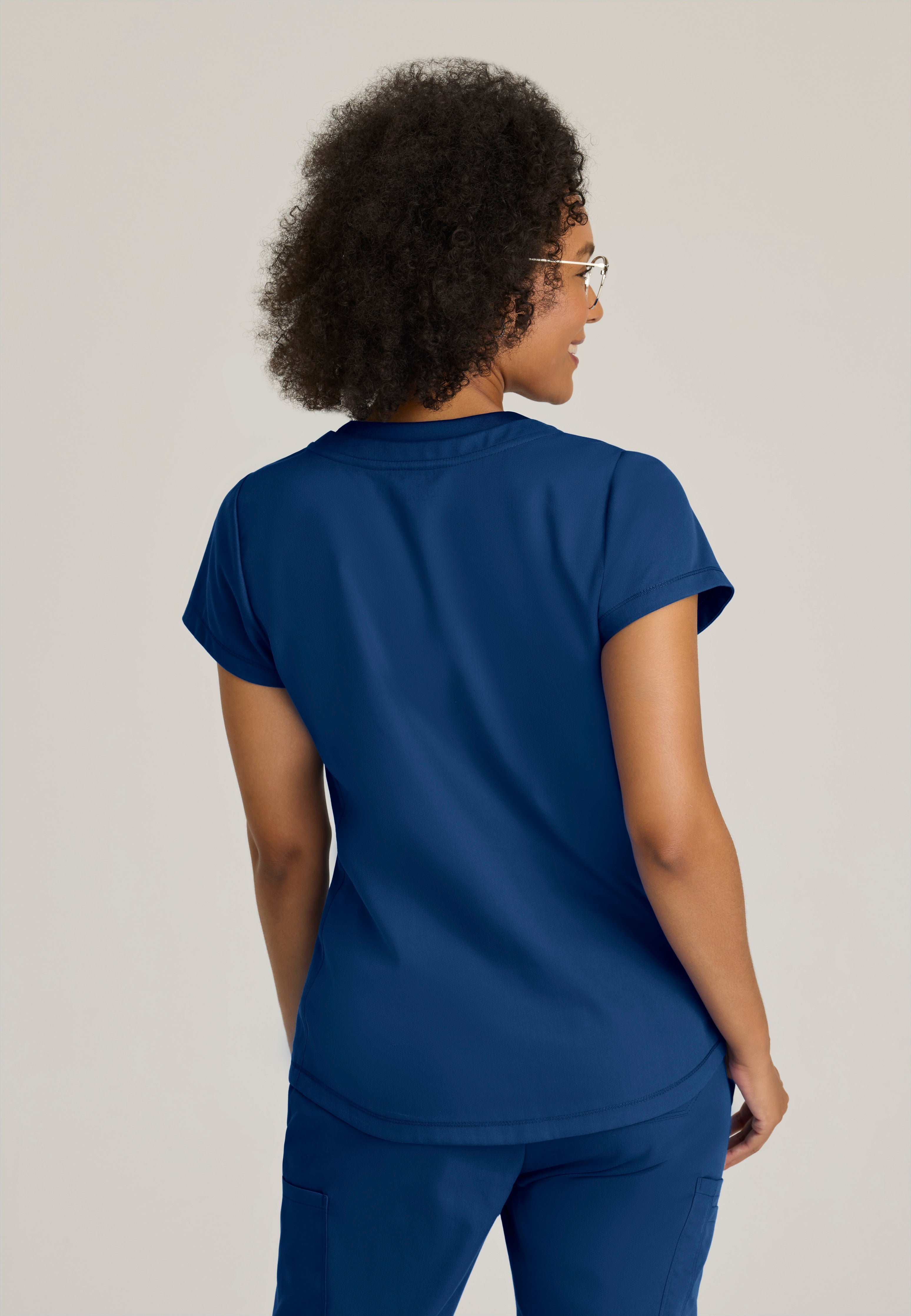 Back View of the Evelyn Pintuck Detail Scrub Top in Indigo from Grey's Anatomy™ by Barco Classic