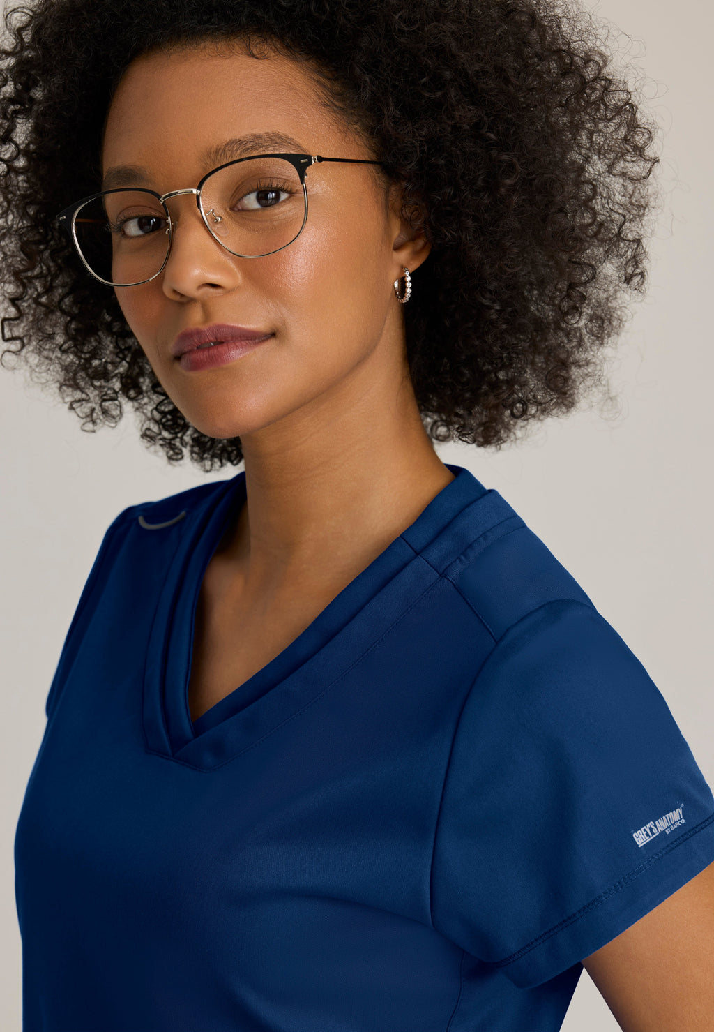 Detail Shot of the Evelyn Pintuck Detail Scrub Top in Indigo from Grey's Anatomy™ by Barco Classic