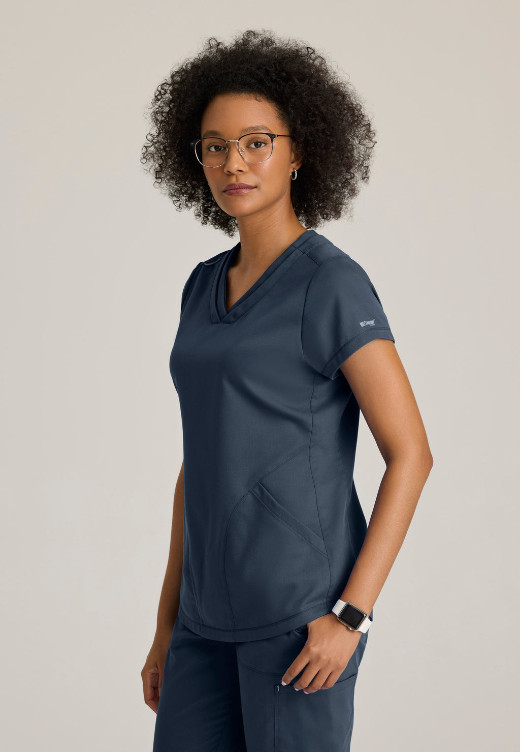 Side View of the Evelyn Pintuck Detail Scrub Top in Steel from Grey's Anatomy™ by Barco Classic