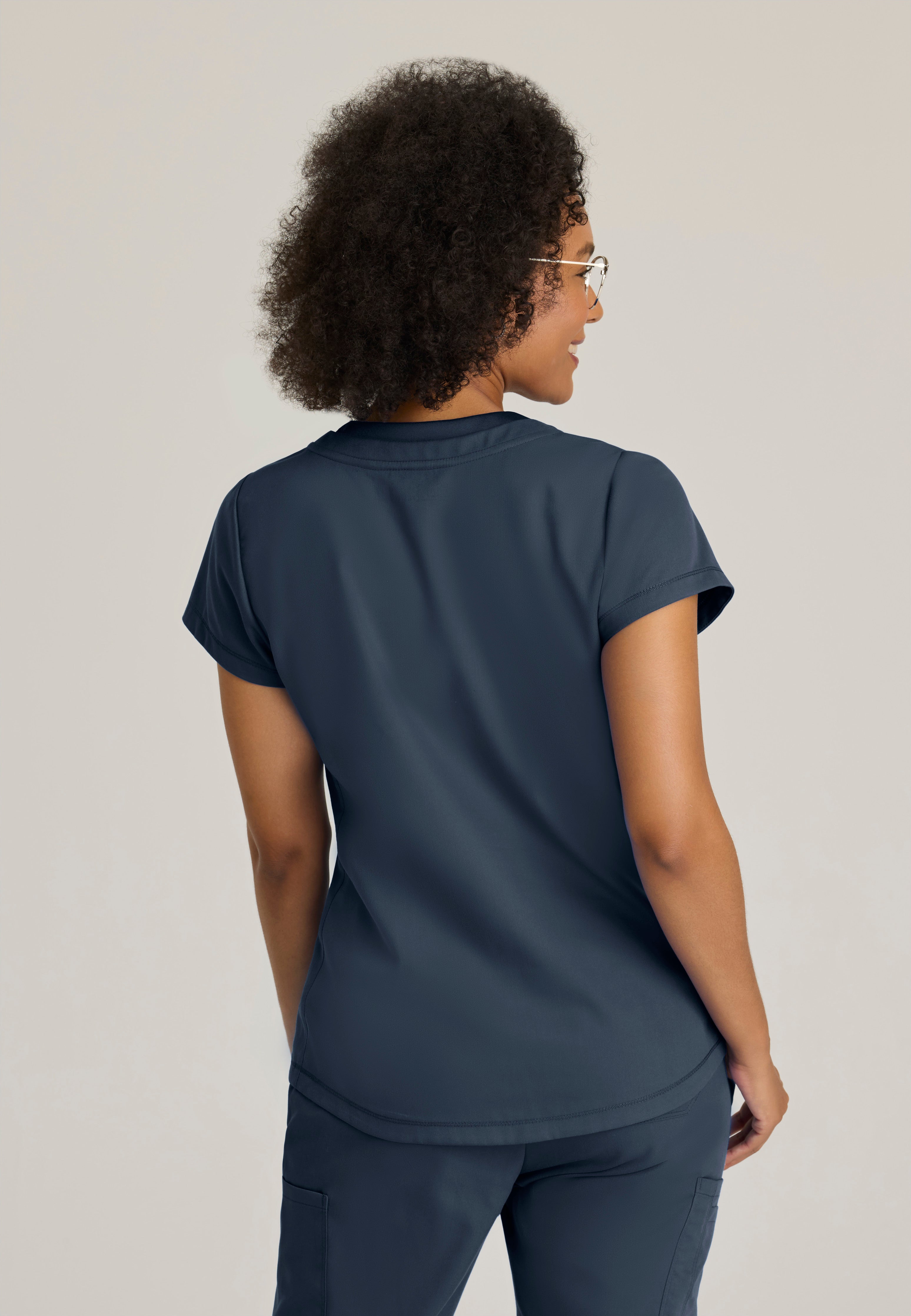Back View of the Evelyn Pintuck Detail Scrub Top in Steel from Grey's Anatomy™ by Barco Classic