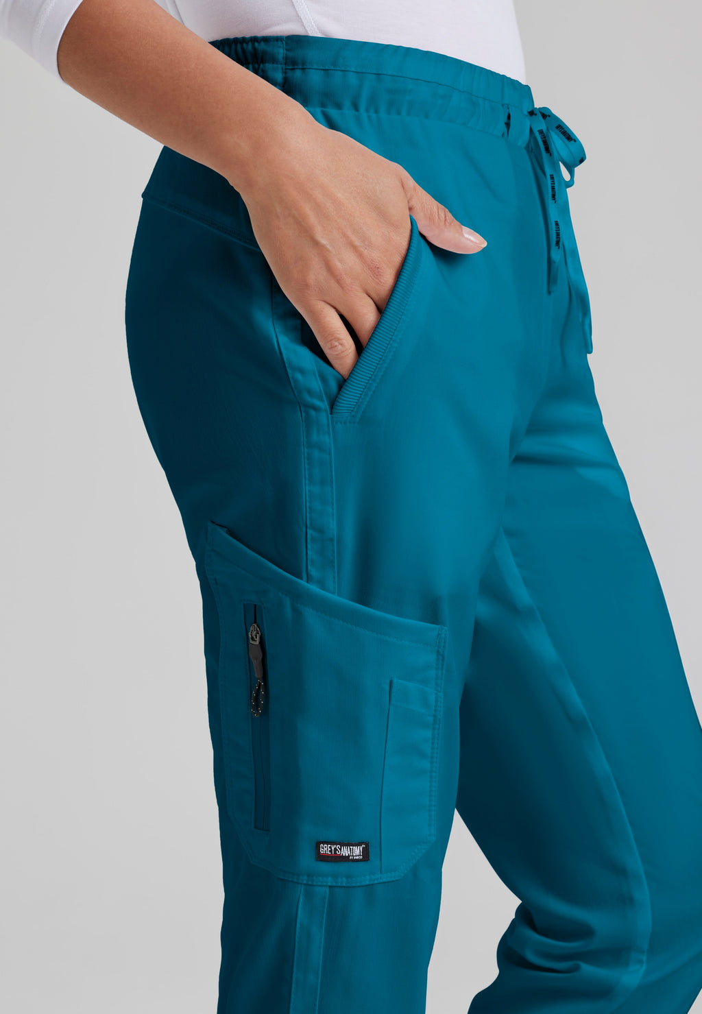 Detail Shot of the Kira 5-Pocket Mid-Rise Jogger Scrub Pant in Bahama from Grey's Anatomy™ by Barco Classic