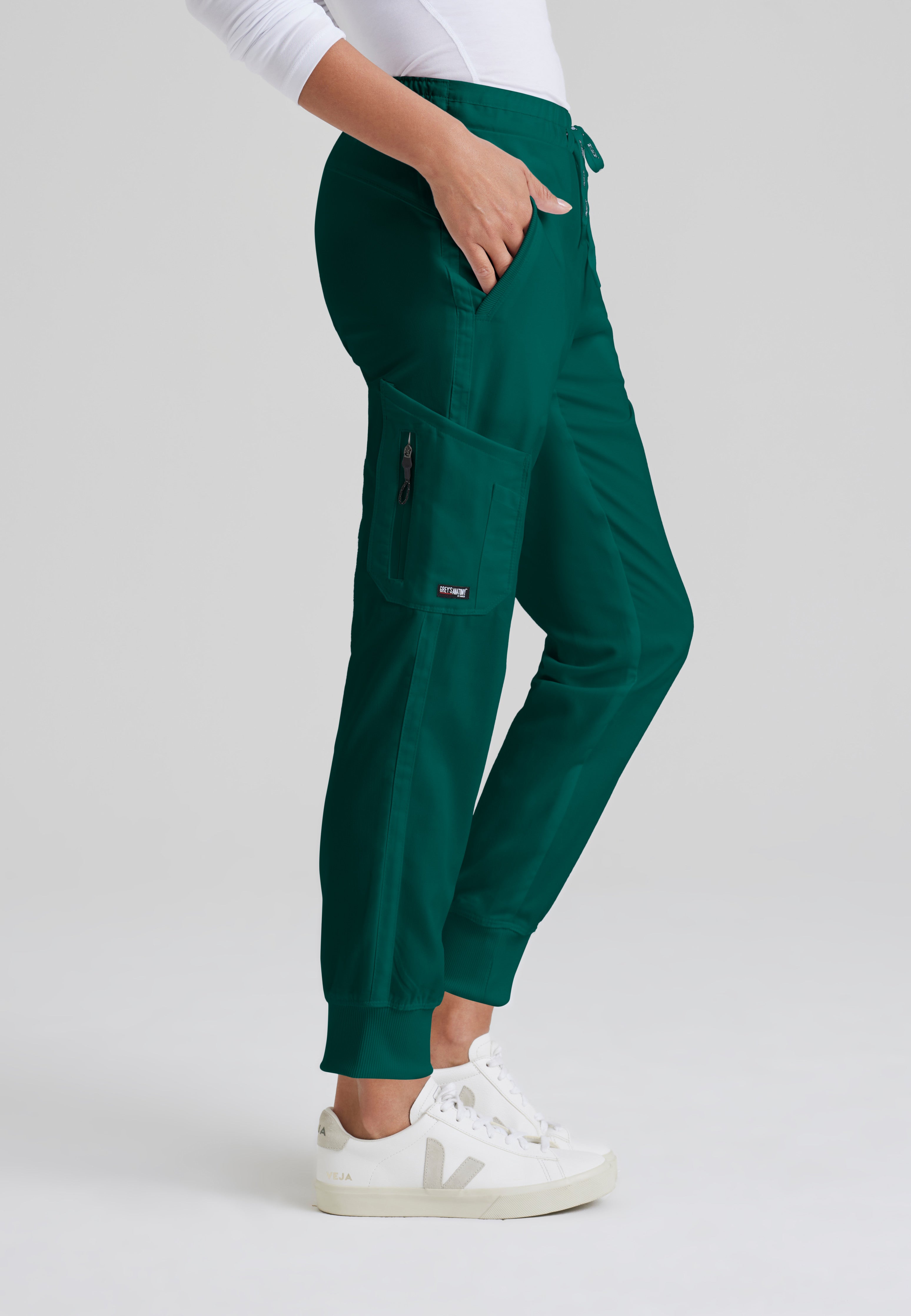 Side View of the Kira 5-Pocket Mid-Rise Jogger Scrub Pant in Hunter Green from Grey's Anatomy™ by Barco Classic