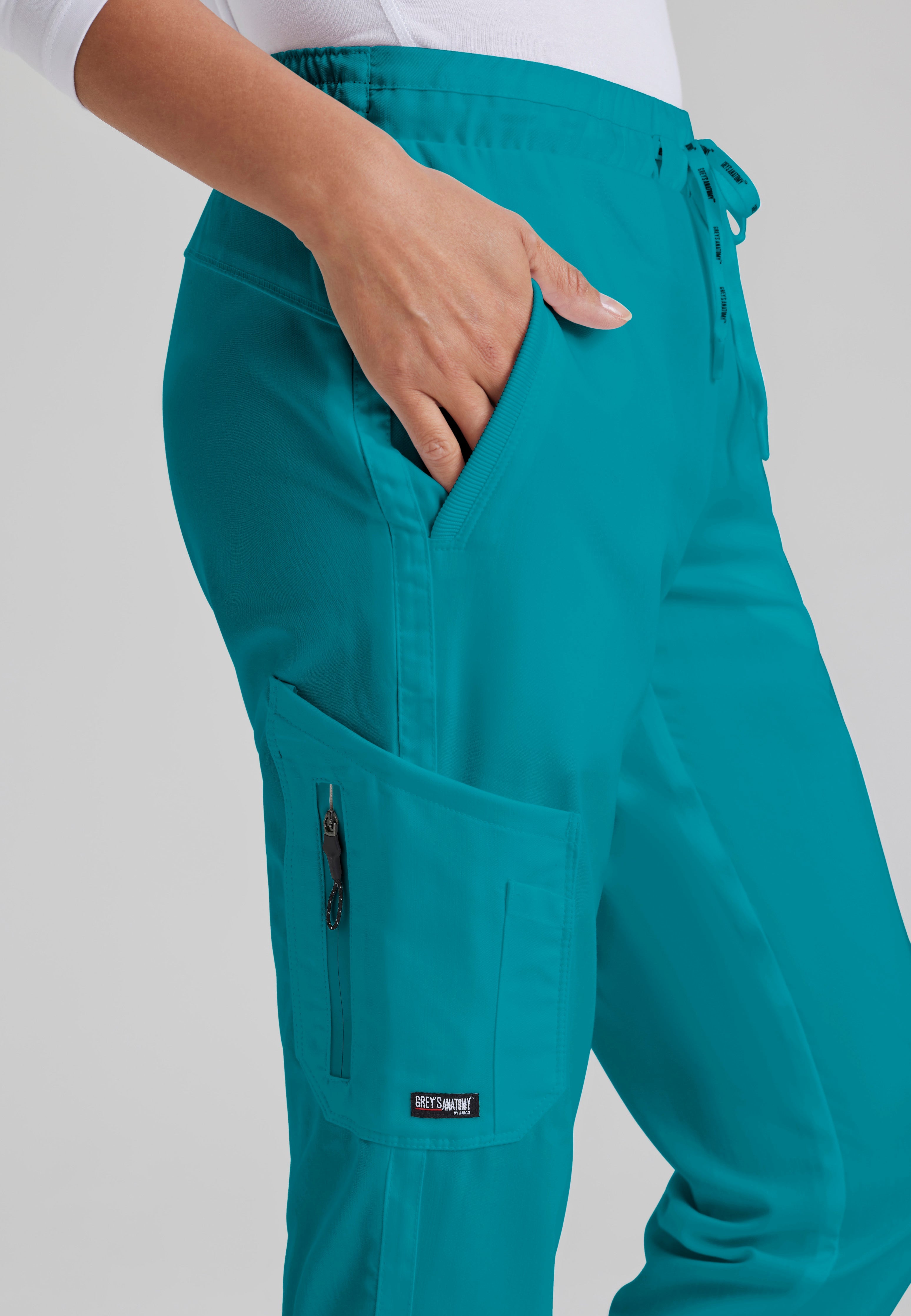 Detail Shot of the Kira 5-Pocket Mid-Rise Jogger Scrub Pant in Teal from Grey's Anatomy™ by Barco Classic
