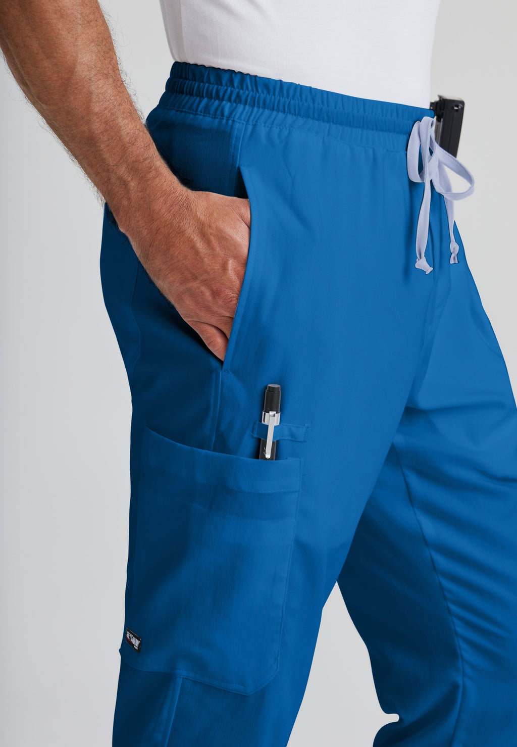 Detail Shot of the Evan 5-Pocket Zip-Fly Scrub Pant in New Royal from Grey's Anatomy™ by Barco Classic