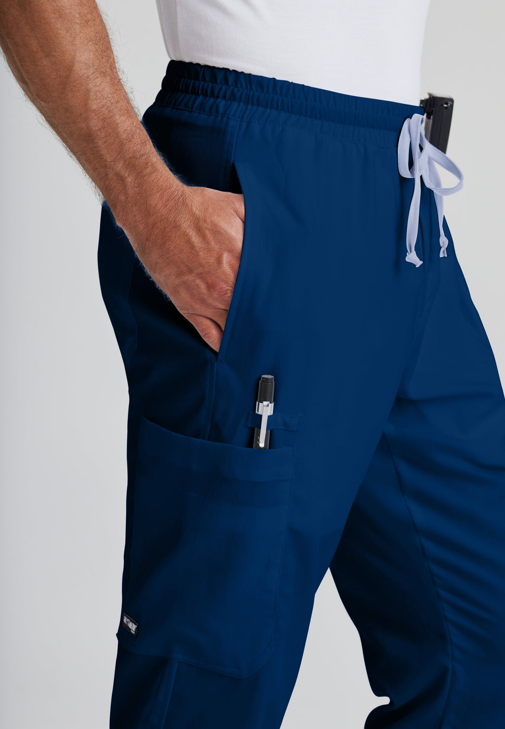 Detail Shot of the Evan 5-Pocket Zip-Fly Scrub Pant in Indigo from Grey's Anatomy™ by Barco Classic