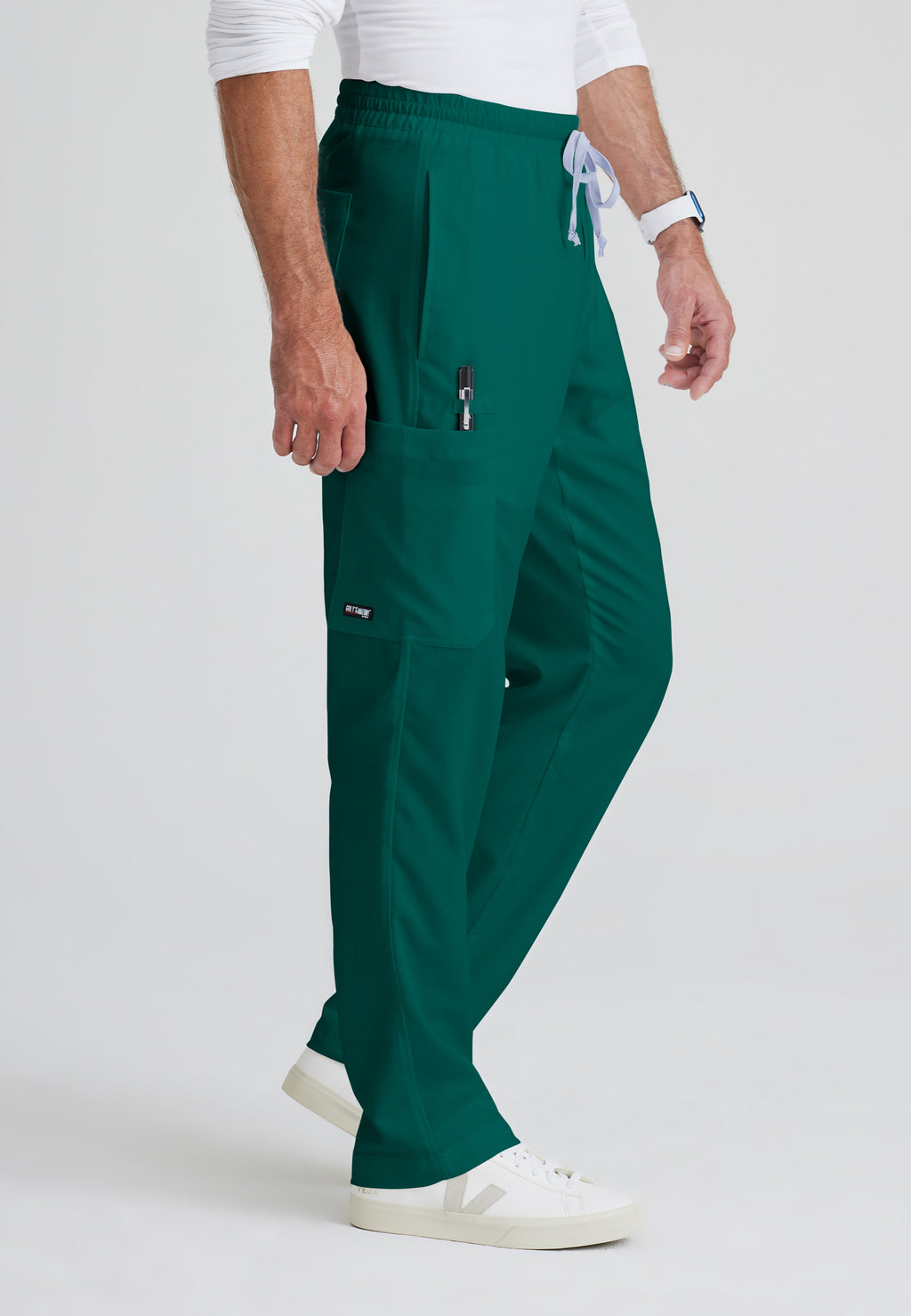 Side View of the Evan 5-Pocket Zip-Fly Scrub Pant in Hunter Green from Grey's Anatomy™ by Barco Classic