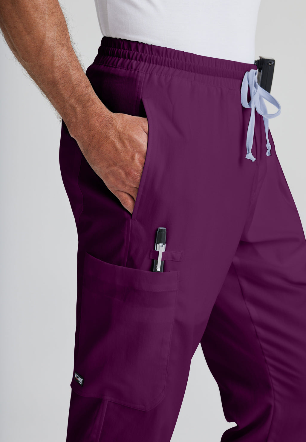 Detail Shot of the Evan 5-Pocket Zip-Fly Scrub Pant in Wine from Grey's Anatomy™ by Barco Classic