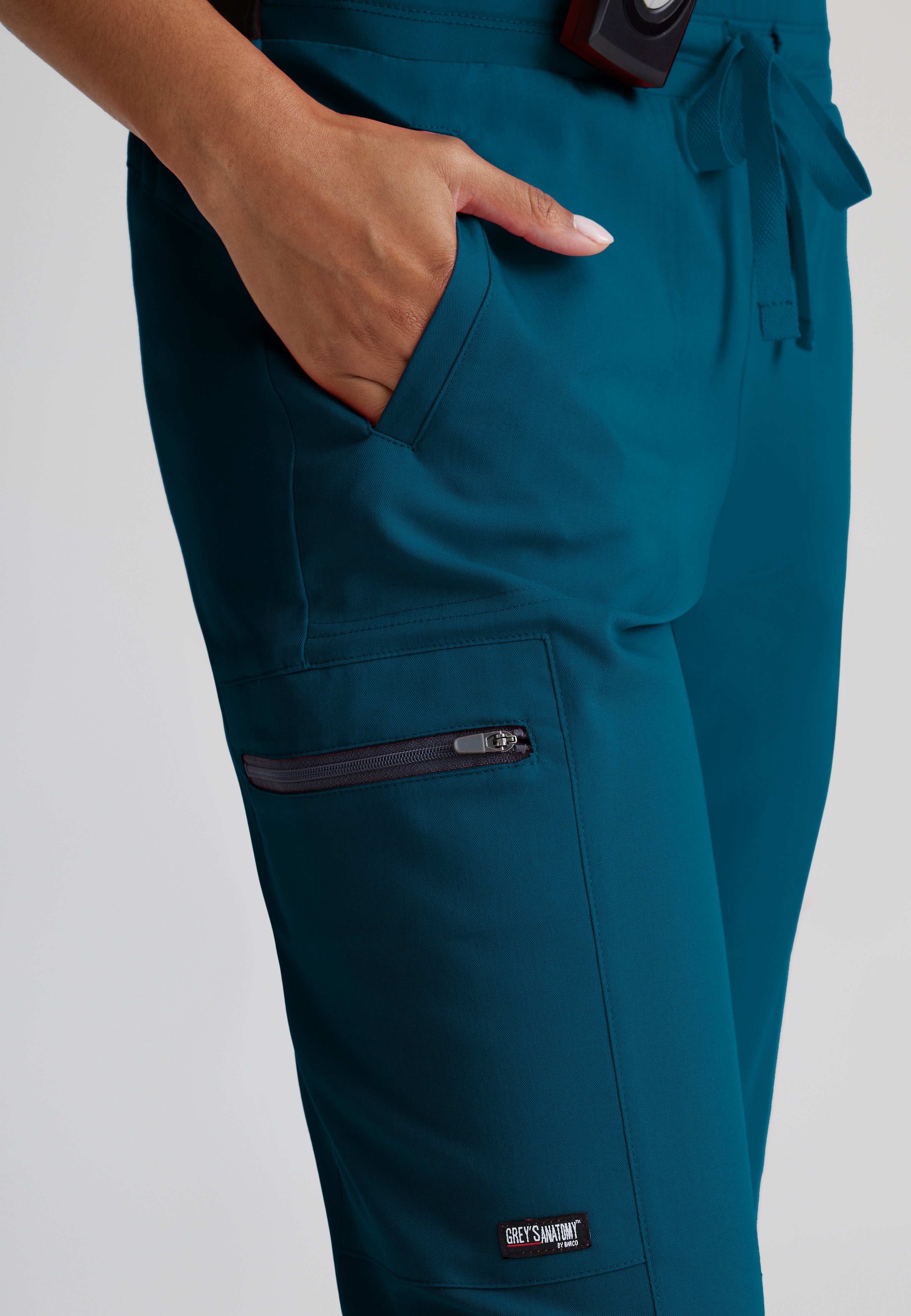 Detail Shot of the Kim 3-Pocket Mid-Rise Straight Leg Scrub Pant in Bahama from Grey's Anatomy™ by Barco Spandex Stretch