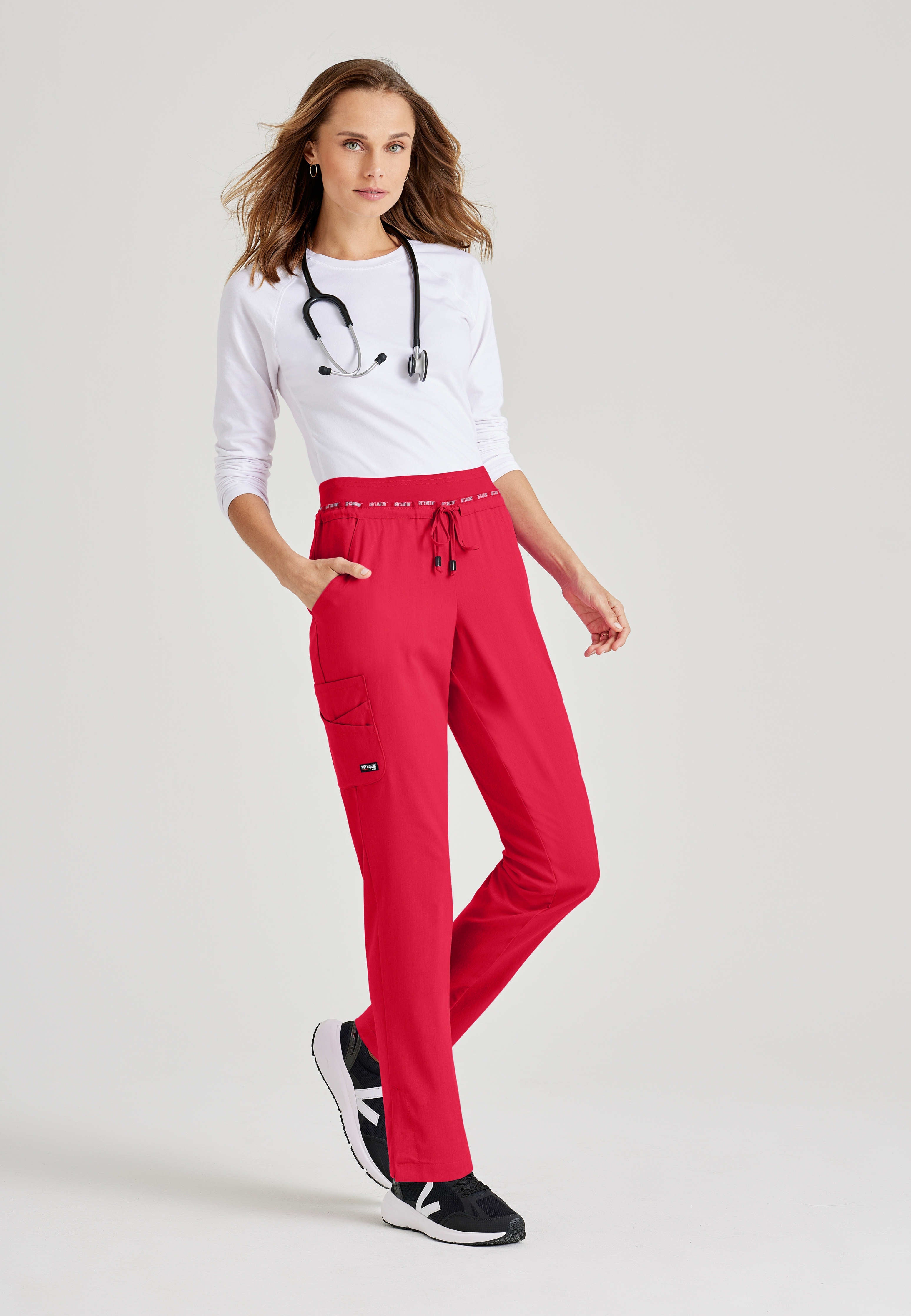 Full Body View of the Serena 7-Pocket Mid-Rise Tappered Leg Scrub Pant in Scarlet Red from Grey's Anatomy™ by Barco Spandex Stretch