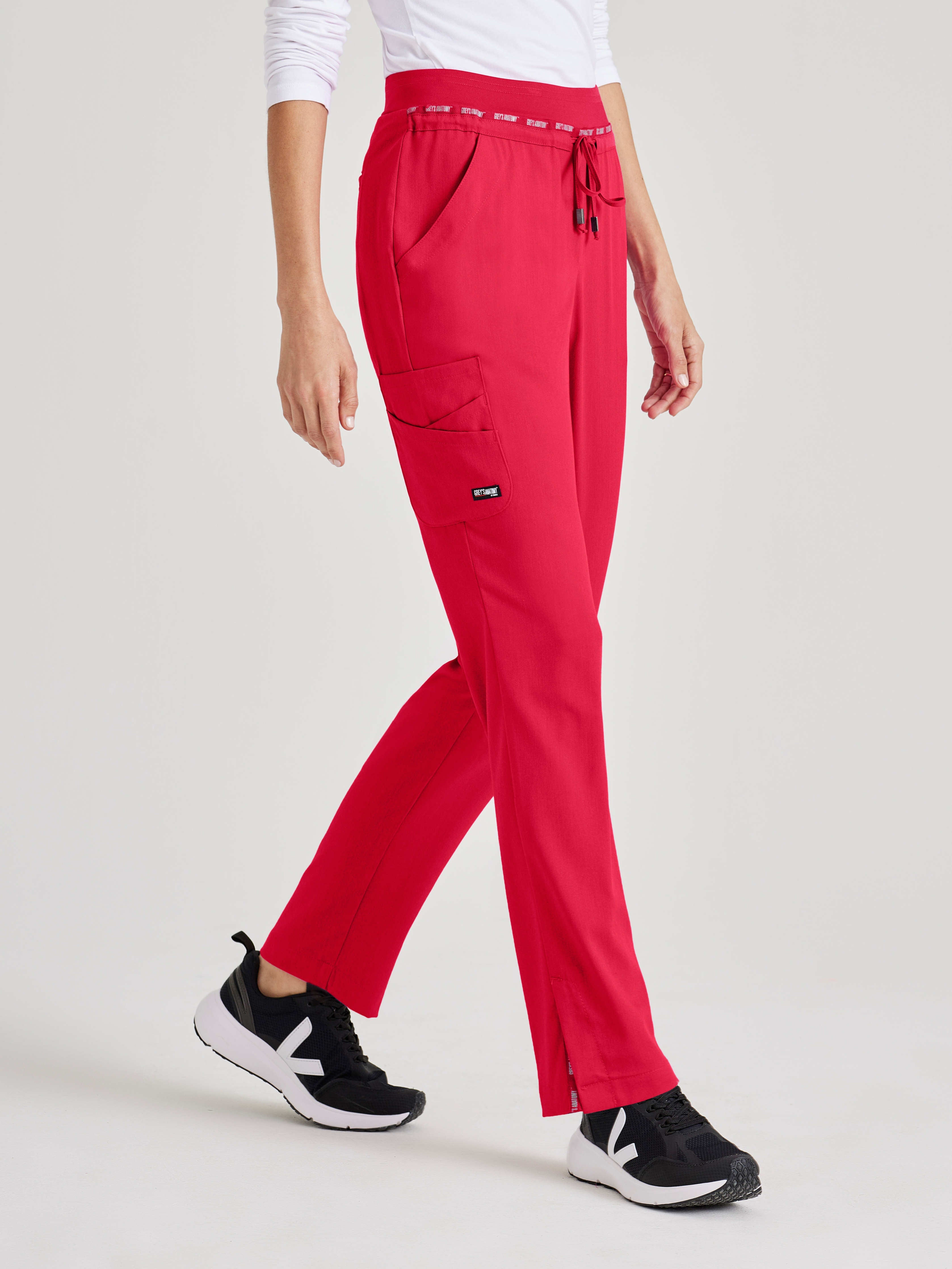 Side View of the Serena 7-Pocket Mid-Rise Tappered Leg Scrub Pant in Scarlet Red from Grey's Anatomy™ by Barco Spandex Stretch