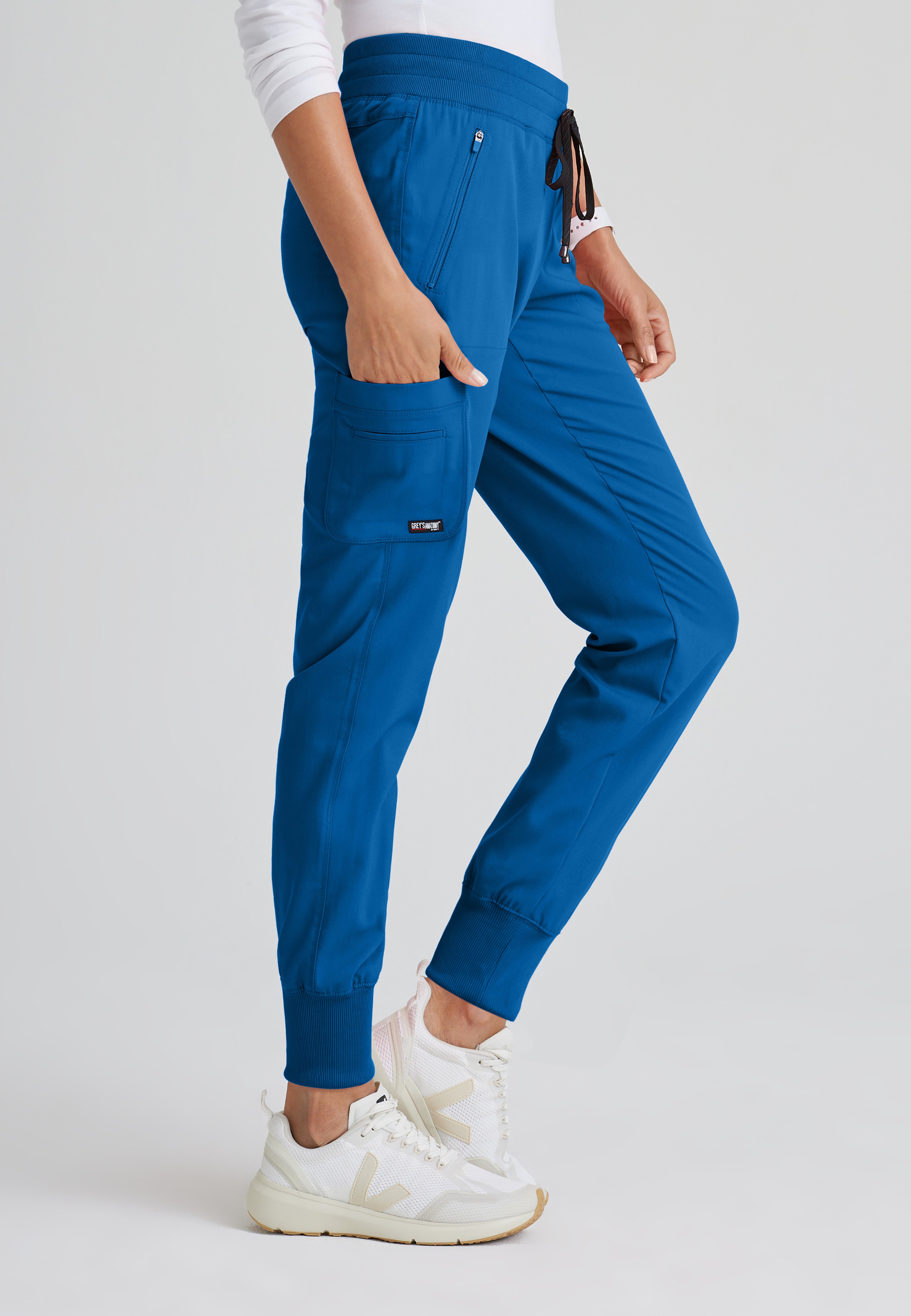 Side View of the Eden 5-Pocket Mid-Rise Jogger Scrub Pant in New Royal from Grey's Anatomy™ by Barco Spandex Stretch