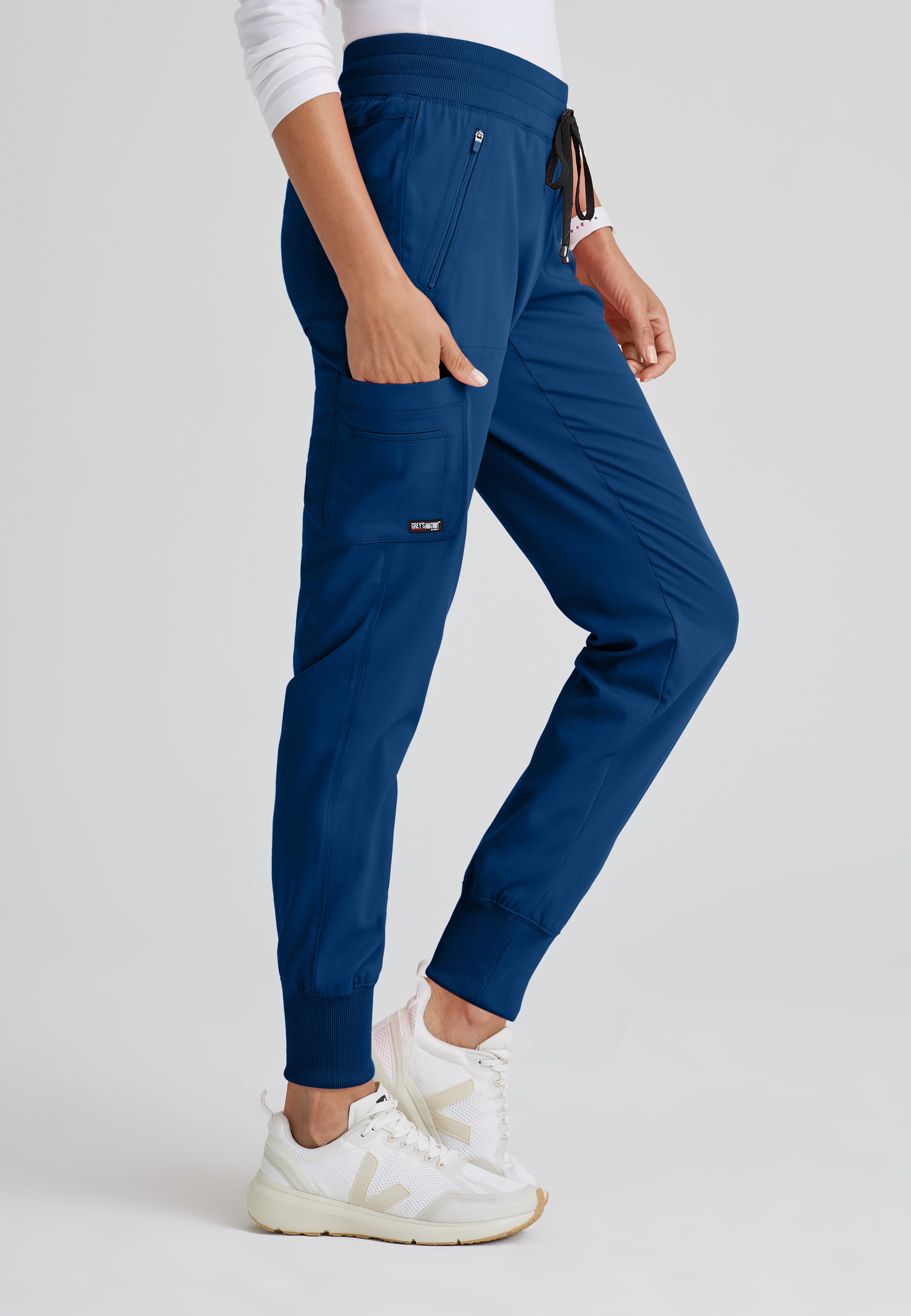 Side View of the Eden 5-Pocket Mid-Rise Jogger Scrub Pant in Indigo from Grey's Anatomy™ by Barco Spandex Stretch