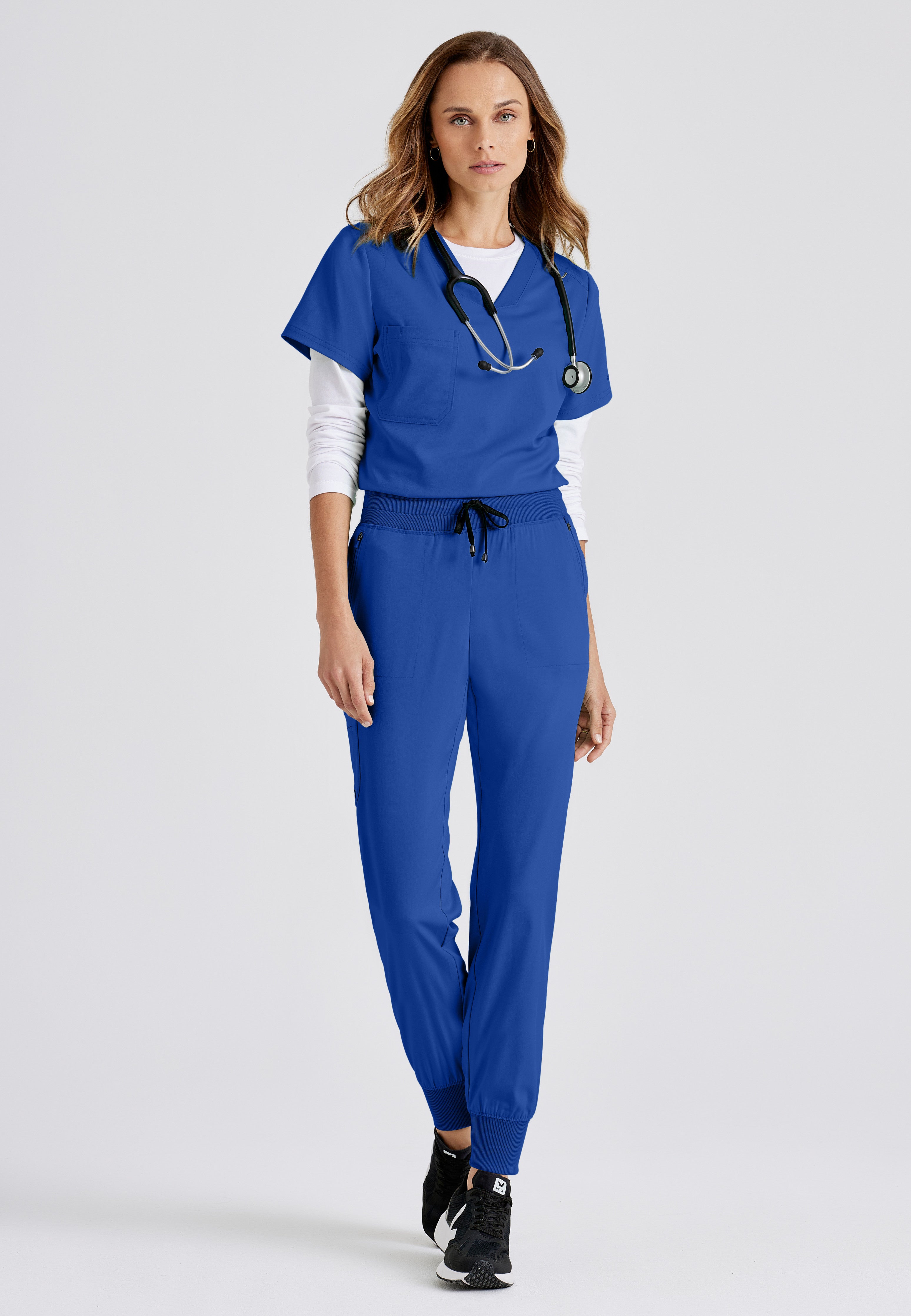 Full Body View of the Eden 5-Pocket Mid-Rise Jogger Scrub Pant in Galaxy from Grey's Anatomy™ by Barco Spandex Stretch