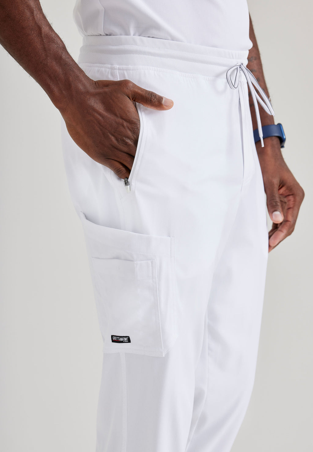 Grey's Anatomy Spandex-Stretch Men’s white Zip-Fly 5-Pocket Jogger Scrub Pant. Elastic waistband with drawstring. Wrinkle-resistant, easy care fabric. 