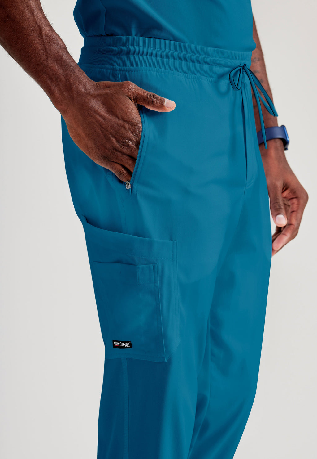 Grey's Anatomy Spandex-Stretch Men’s Bahama Zip-Fly 5-Pocket Jogger Scrub Pant. Elastic waistband with drawstring. Wrinkle-resistant, easy care fabric. 