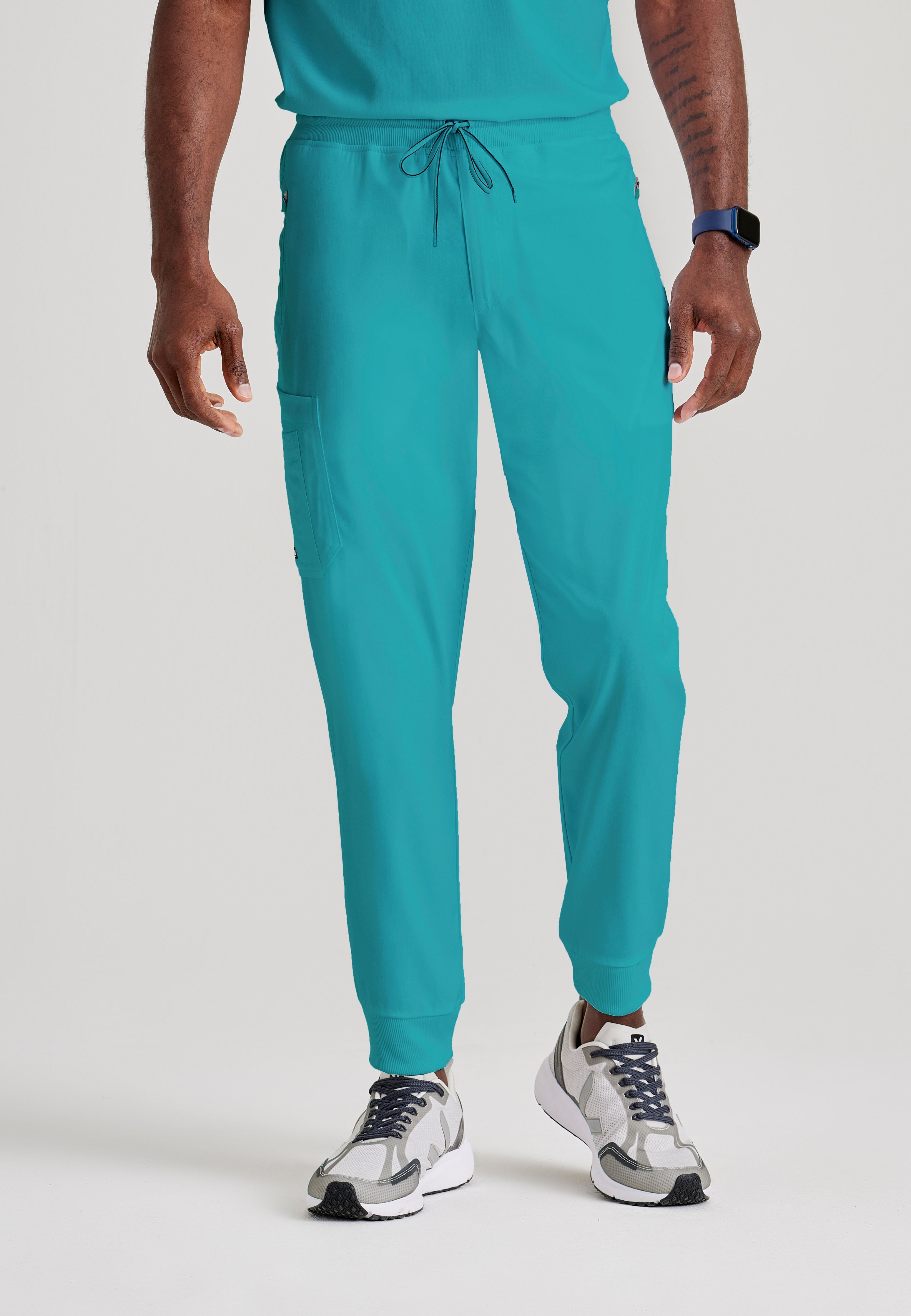 Grey's Anatomy Spandex-Stretch Men’s teal Zip-Fly 5-Pocket Jogger Scrub Pant. Elastic waistband with drawstring. Wrinkle-resistant, easy care fabric. 