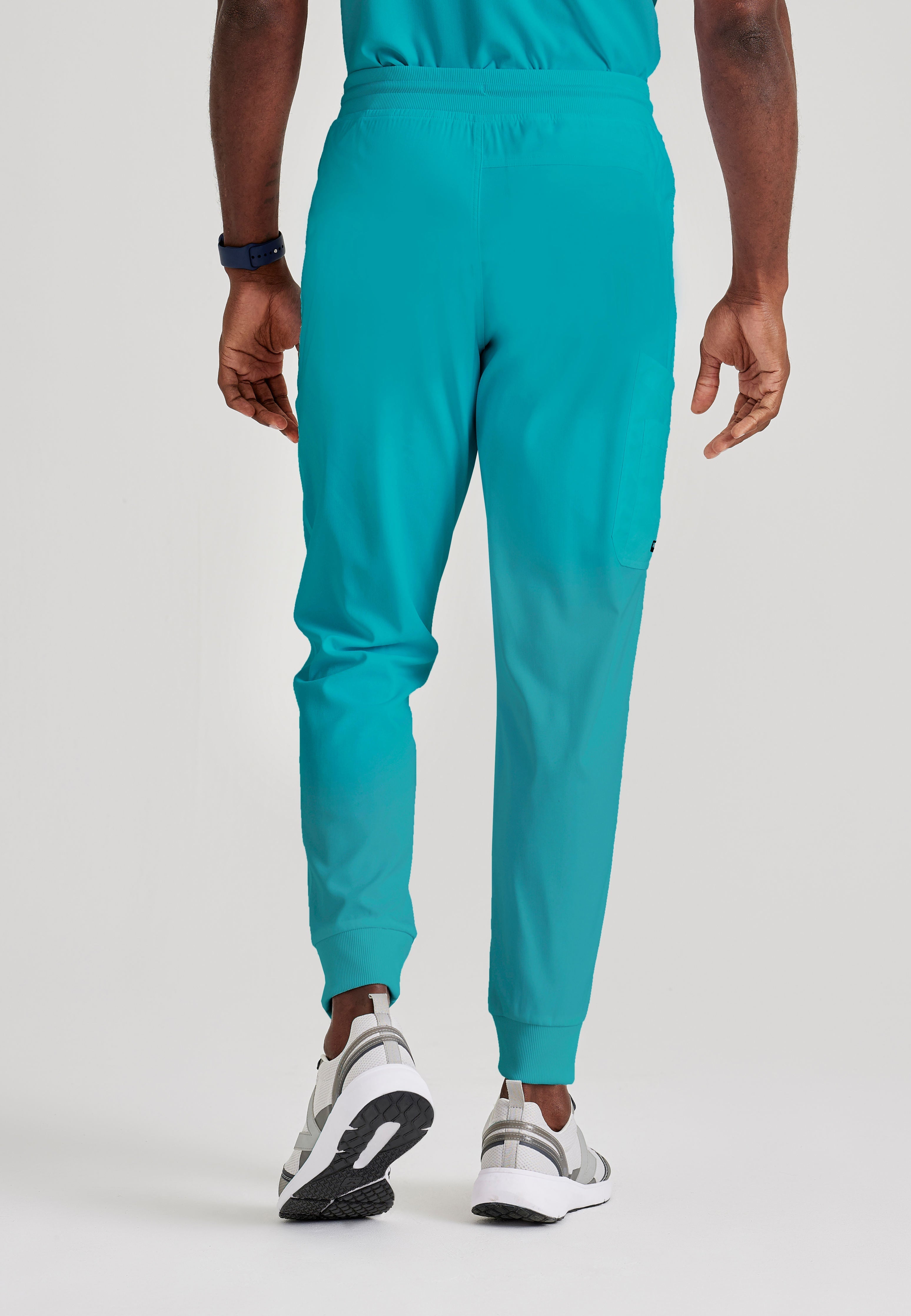 Grey's Anatomy Spandex-Stretch Men’s teal Zip-Fly 5-Pocket Jogger Scrub Pant. Elastic waistband with drawstring. Wrinkle-resistant, easy care fabric. 