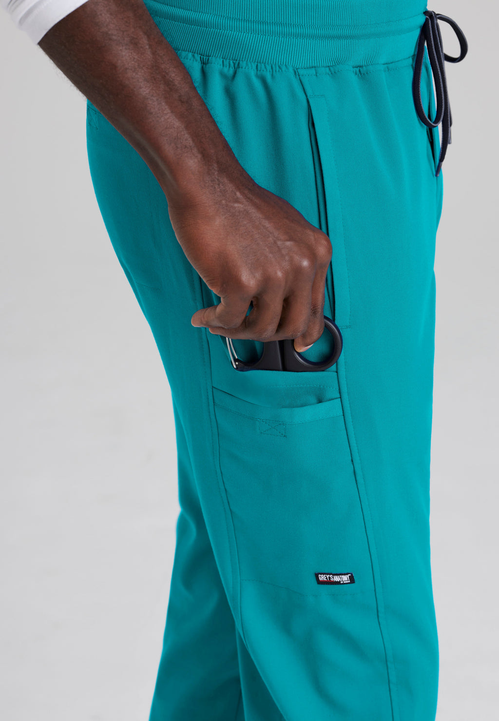 Detail Shot of the Hudson Straight Leg Drawcord Pant in Teal from Grey's Anatomy™ by Barco Spandex Stretch