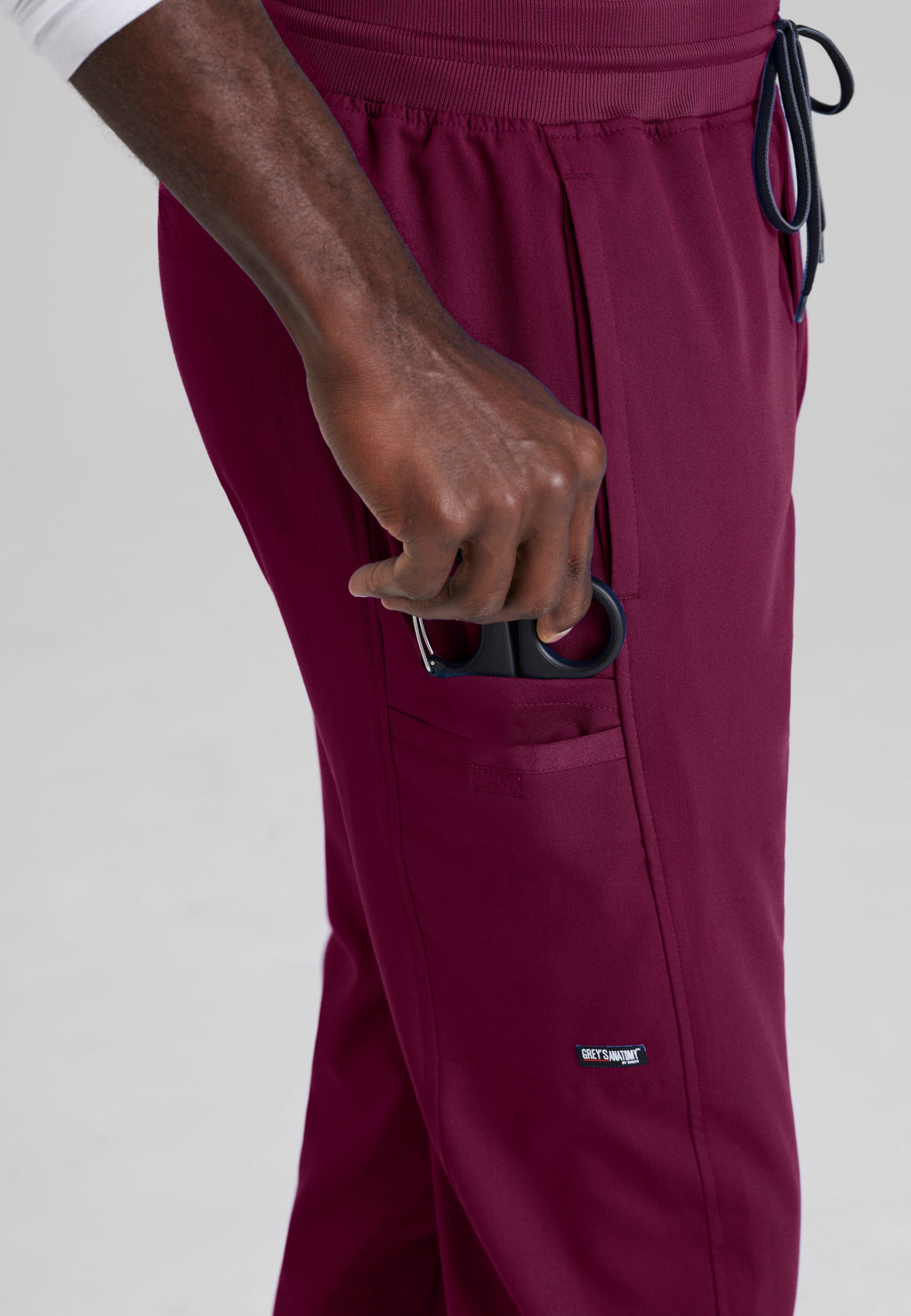 Detail Shot of the Hudson Straight Leg Drawcord Pant in Wine from Grey's Anatomy™ by Barco Spandex Stretch